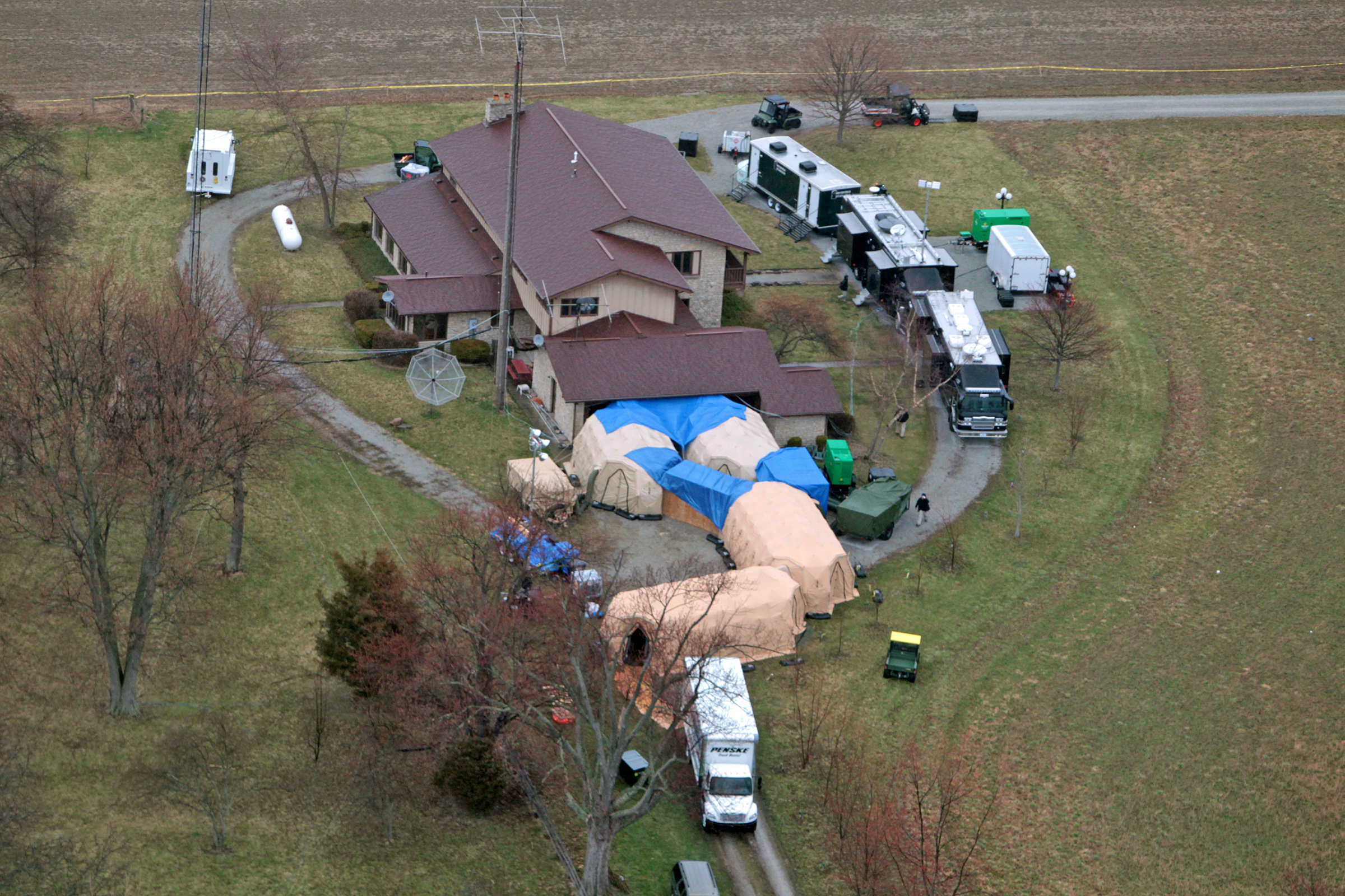 FBI agents work around the home of 91-year-old Donald Miller in Waldron, Ind. on April 2, 2014.