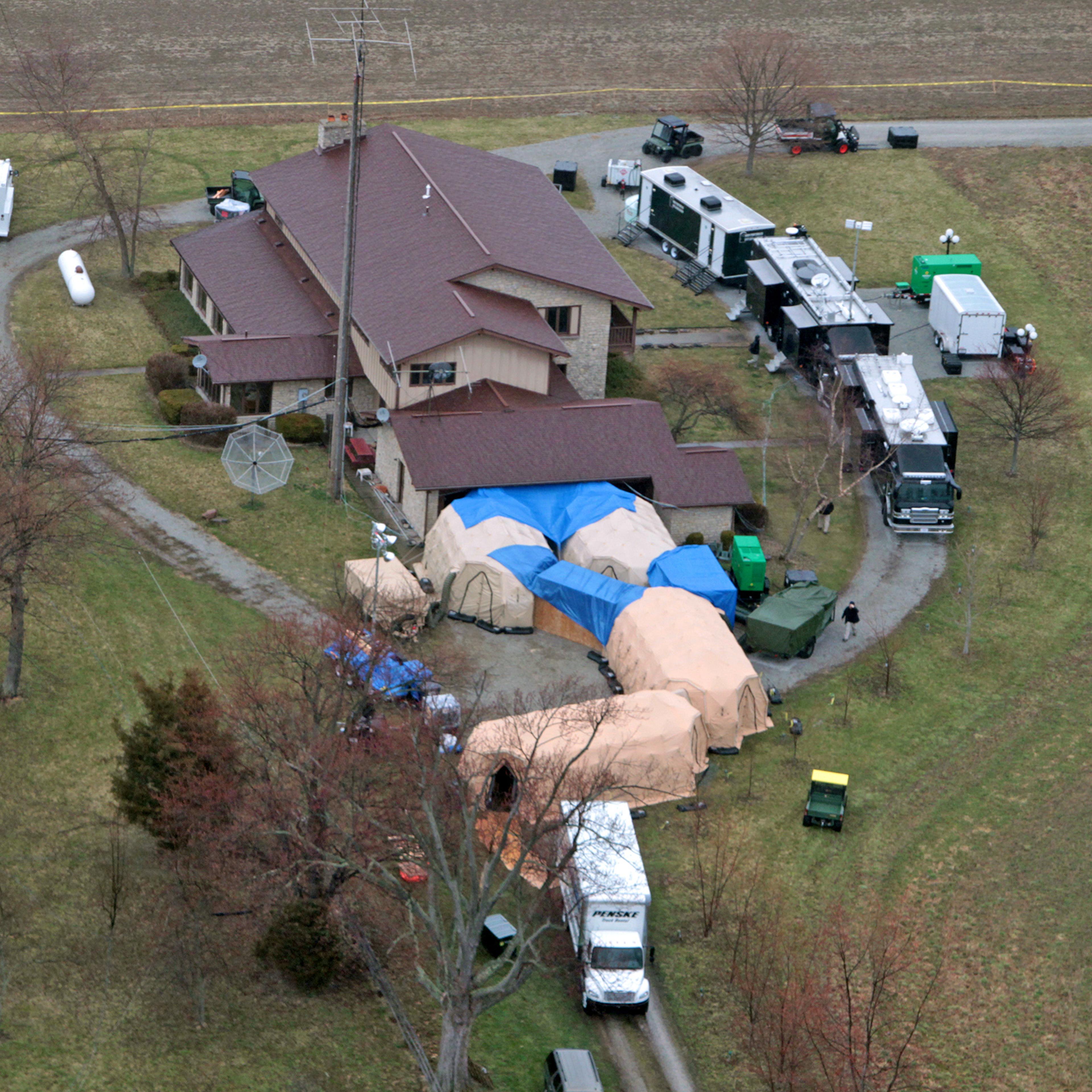 FBI agents work around the home of 91-year-old Donald Miller in Waldron, Ind. on April 2, 2014.