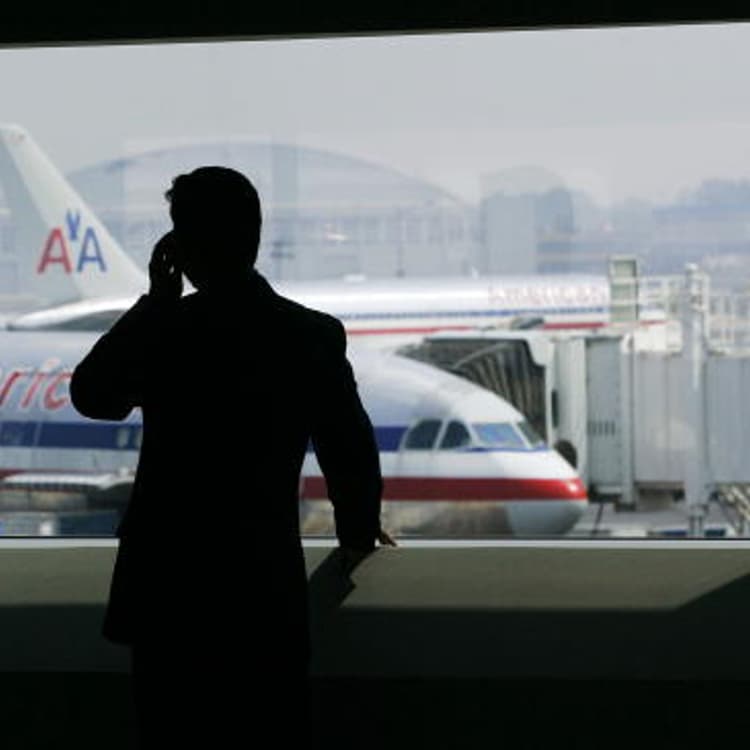 A man talks on a cell phone in the new American Airlines terminal at John F. Kennedy International Airport in New York City, July 27, 2005.