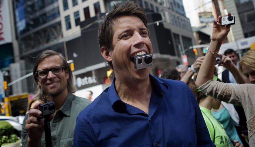 Nick Woodman, founder and chief executive officer of GoPro, looks up at displays of his company's ads in Times Square after the opening bell for the release of the company's IPO at the Nasdaq MarketSite in New York, NY, Thursday June 26, 2014.