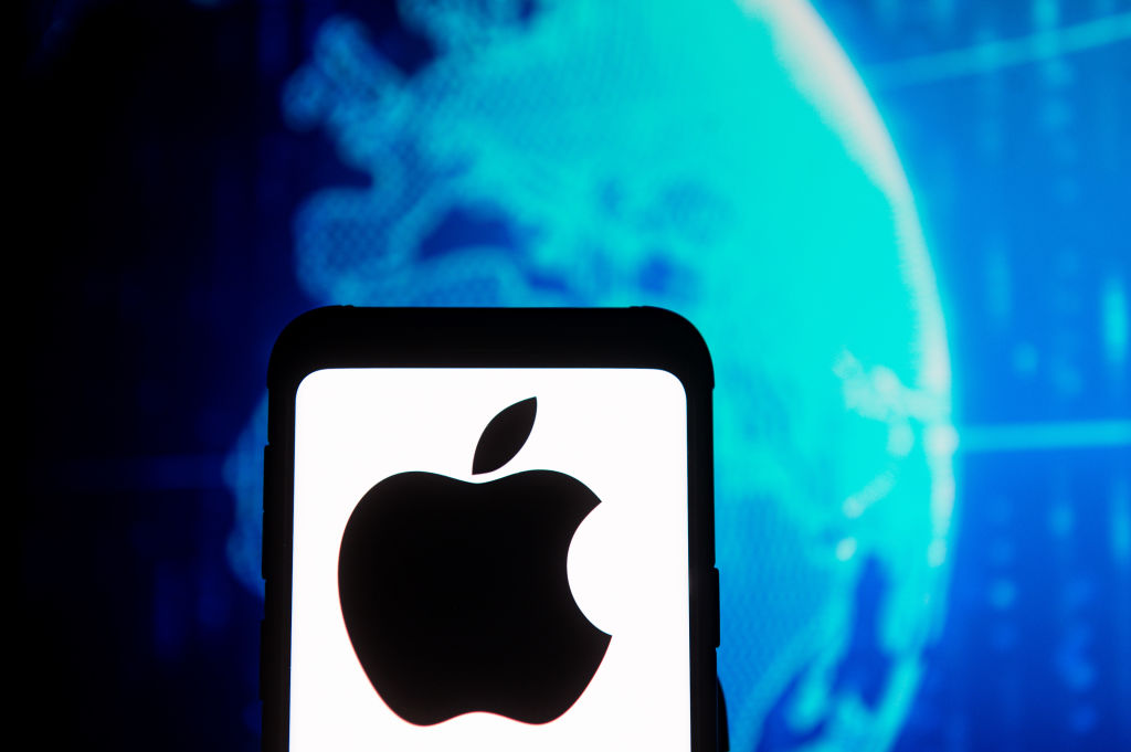In this photo illustration an Apple logo seen displayed on a