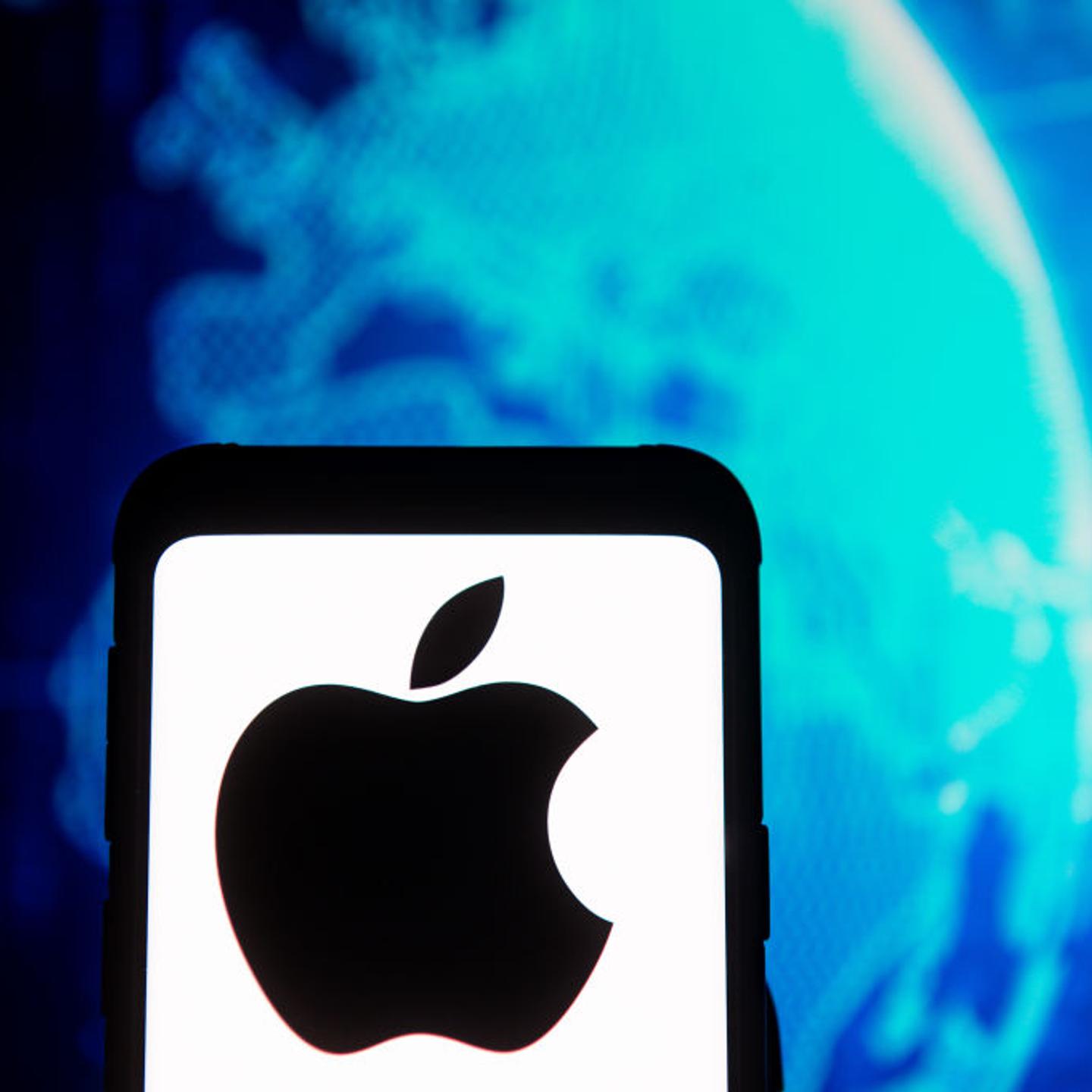 In this photo illustration an Apple logo seen displayed on a