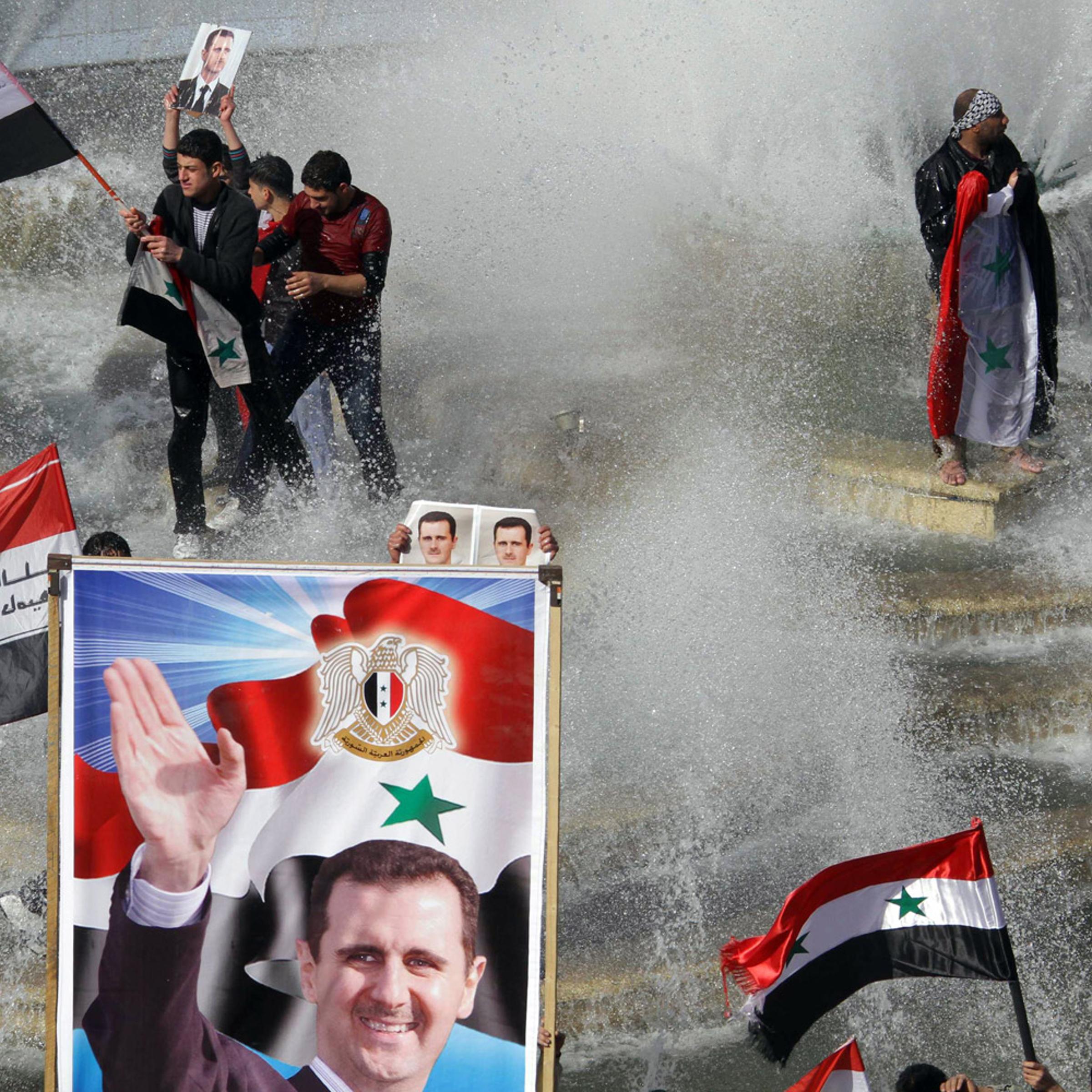 November 13, 2011. Syrians take to a fountain with their national flag to show support for President Bashar Assad after the Arab League suspended Syria because of its treatment of protesters.