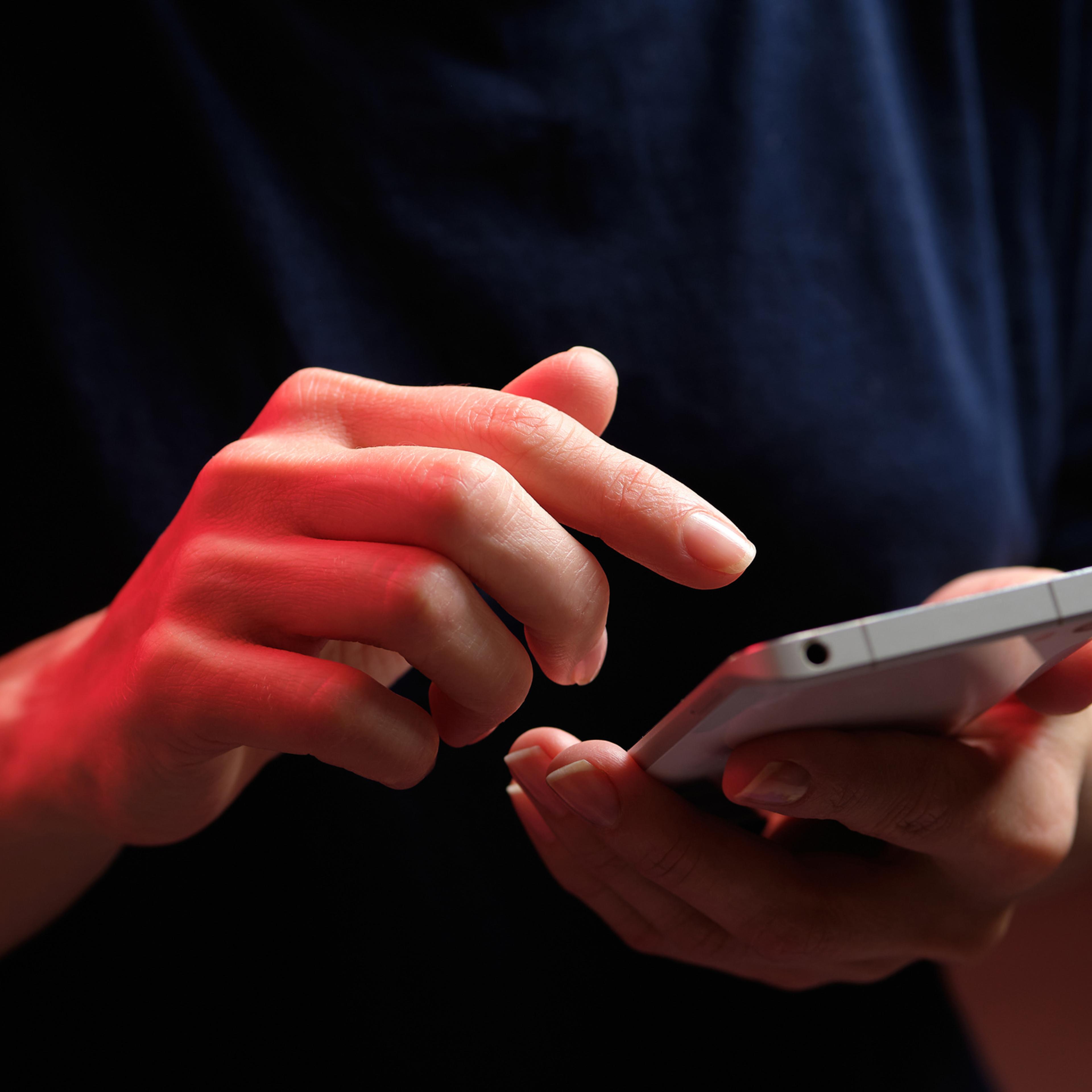 A mobile phone in the hands of a girl.