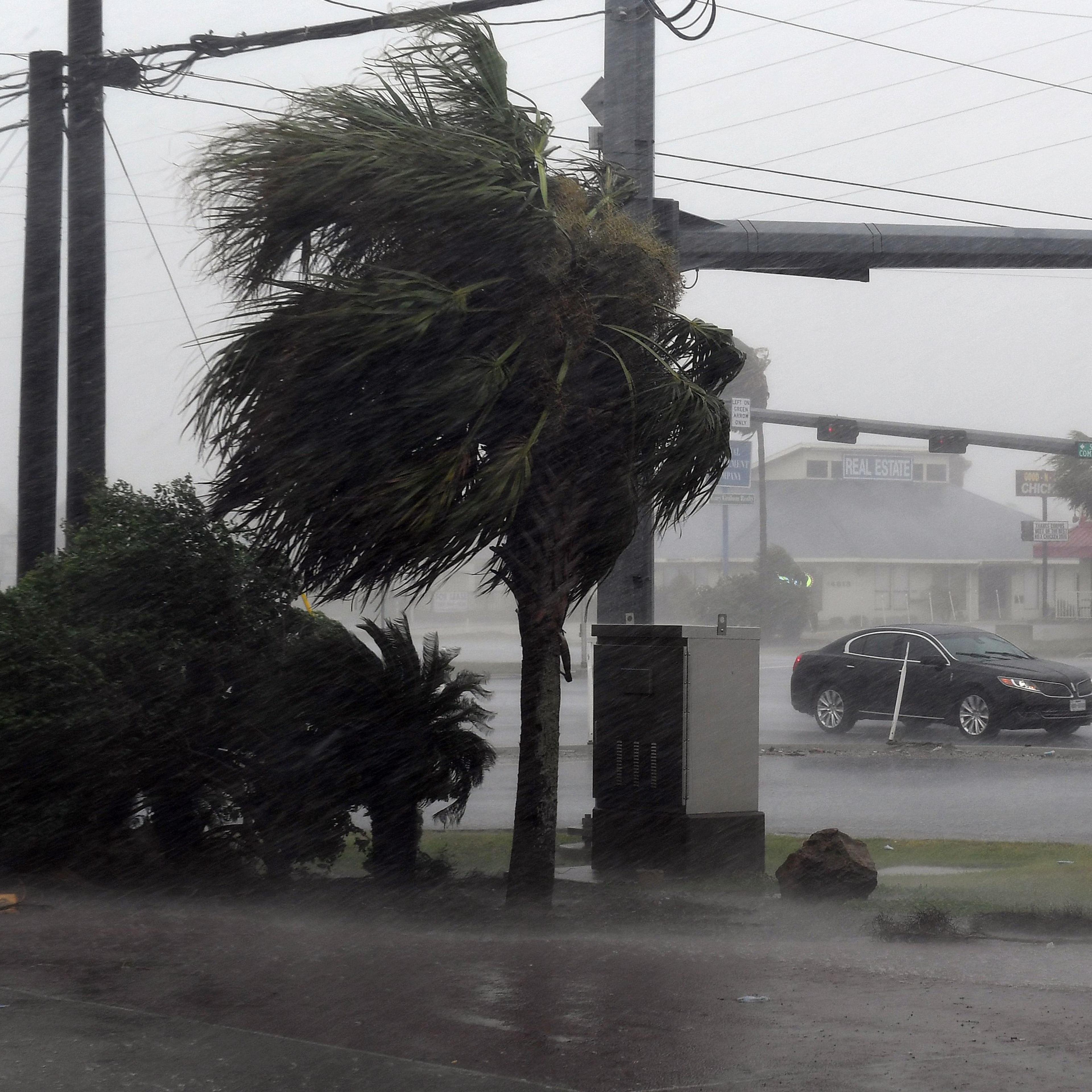 A motorist drives through heavy rain before the approaching Hurricane Harvey hits Corpus Christi, Texas on August 25, 2017.