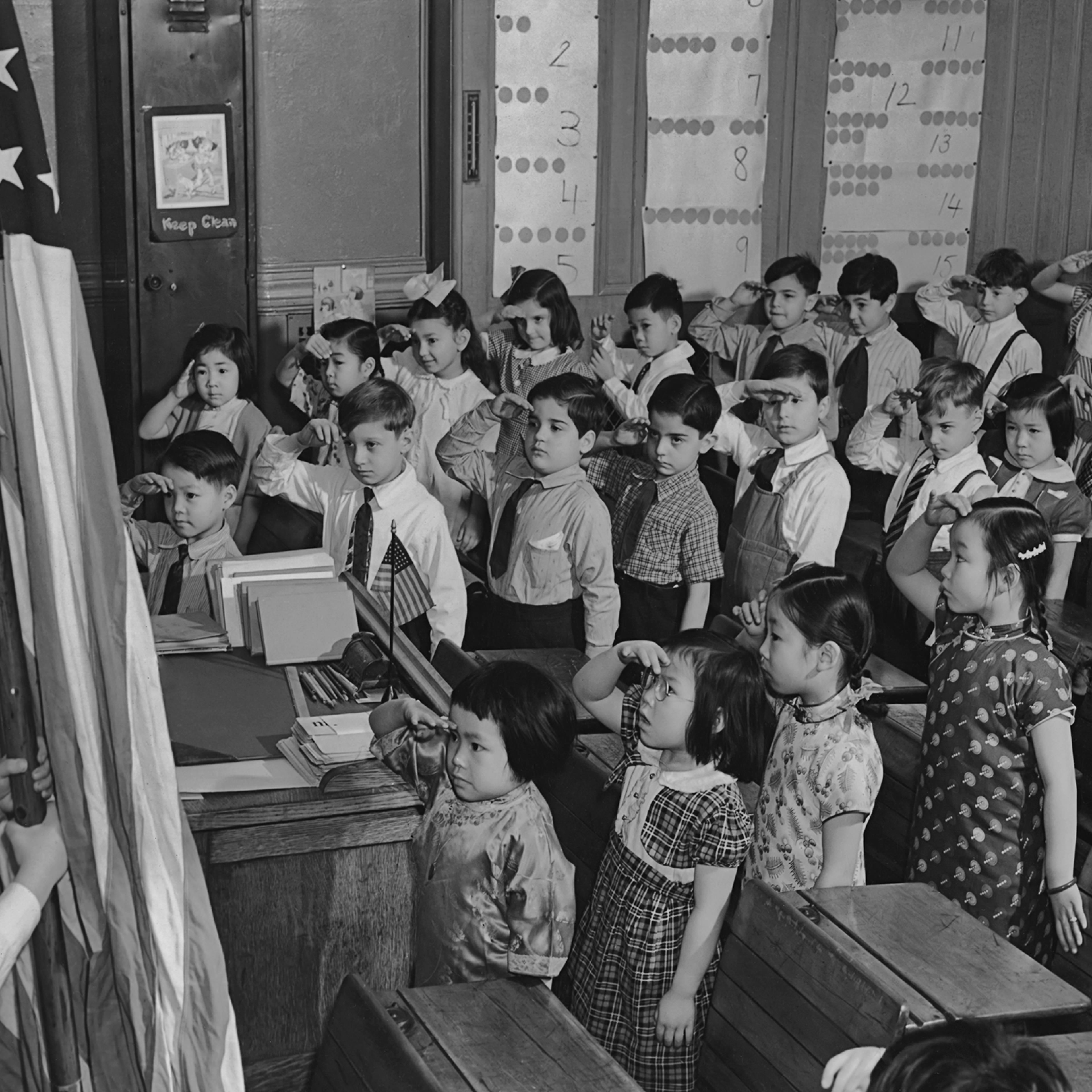 A group of children saluting the American flag at a school in the Chinatown area of Manhattan circa 1960.
