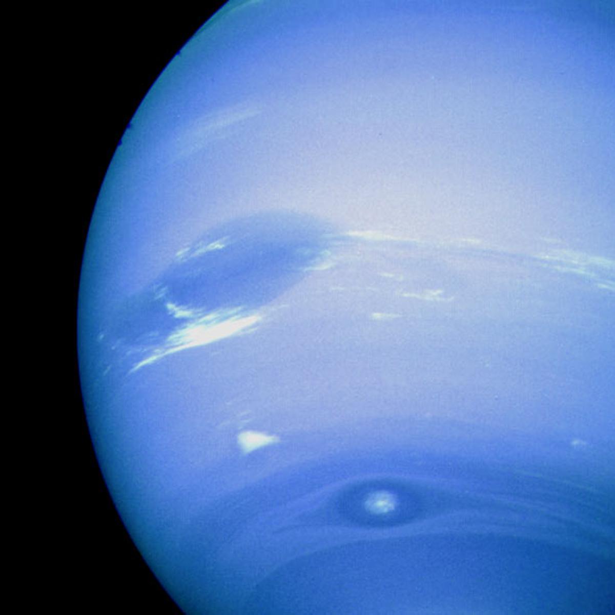 Neptune's Great Dark Spot, accompanied by white high-altitude clouds as photographed by the Voyager 2 spacecraft.