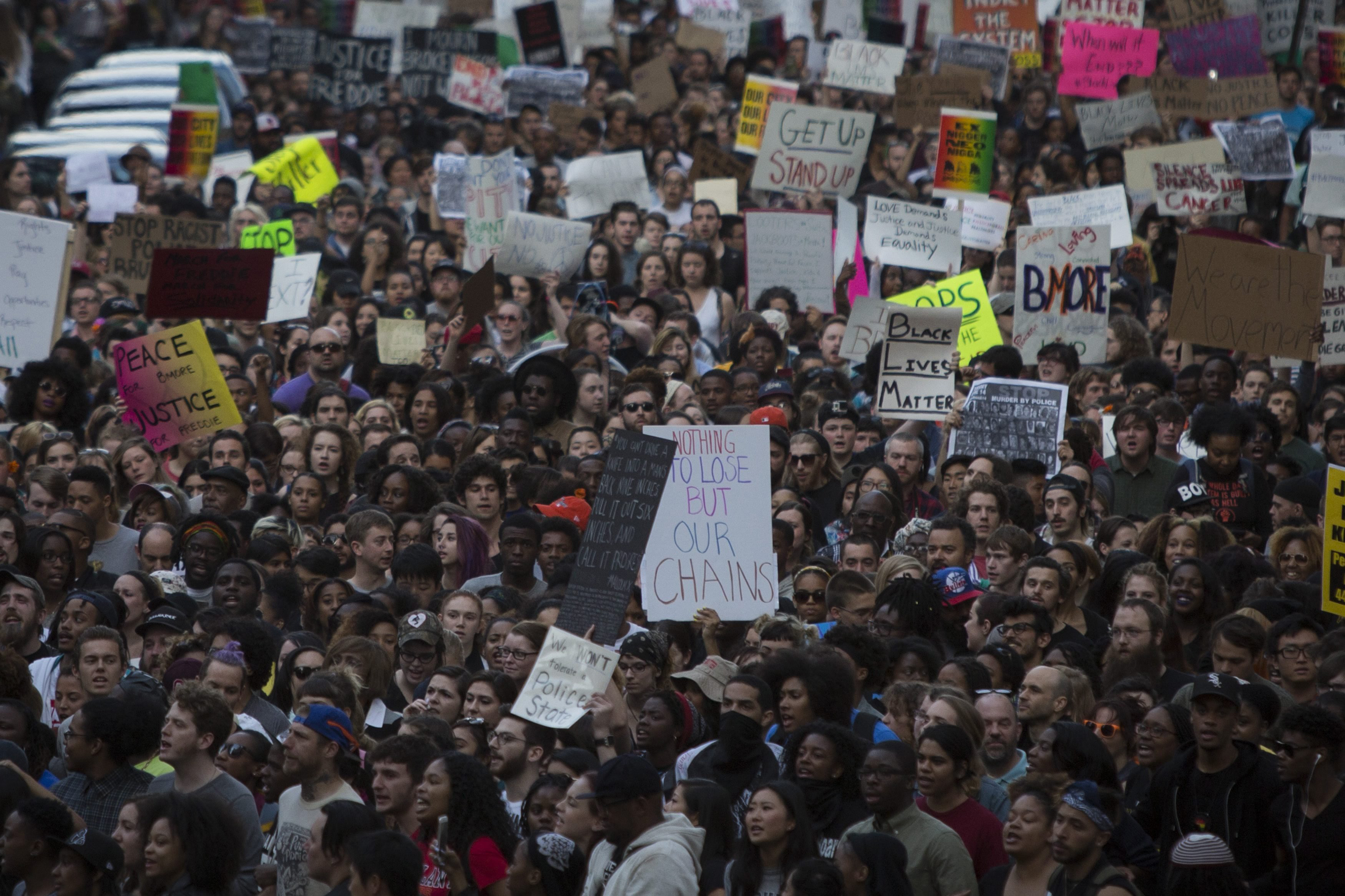 Protesters march near City Hall in Baltimore, on April 29, 2015, demonstrating against the death of Freddie Gray.