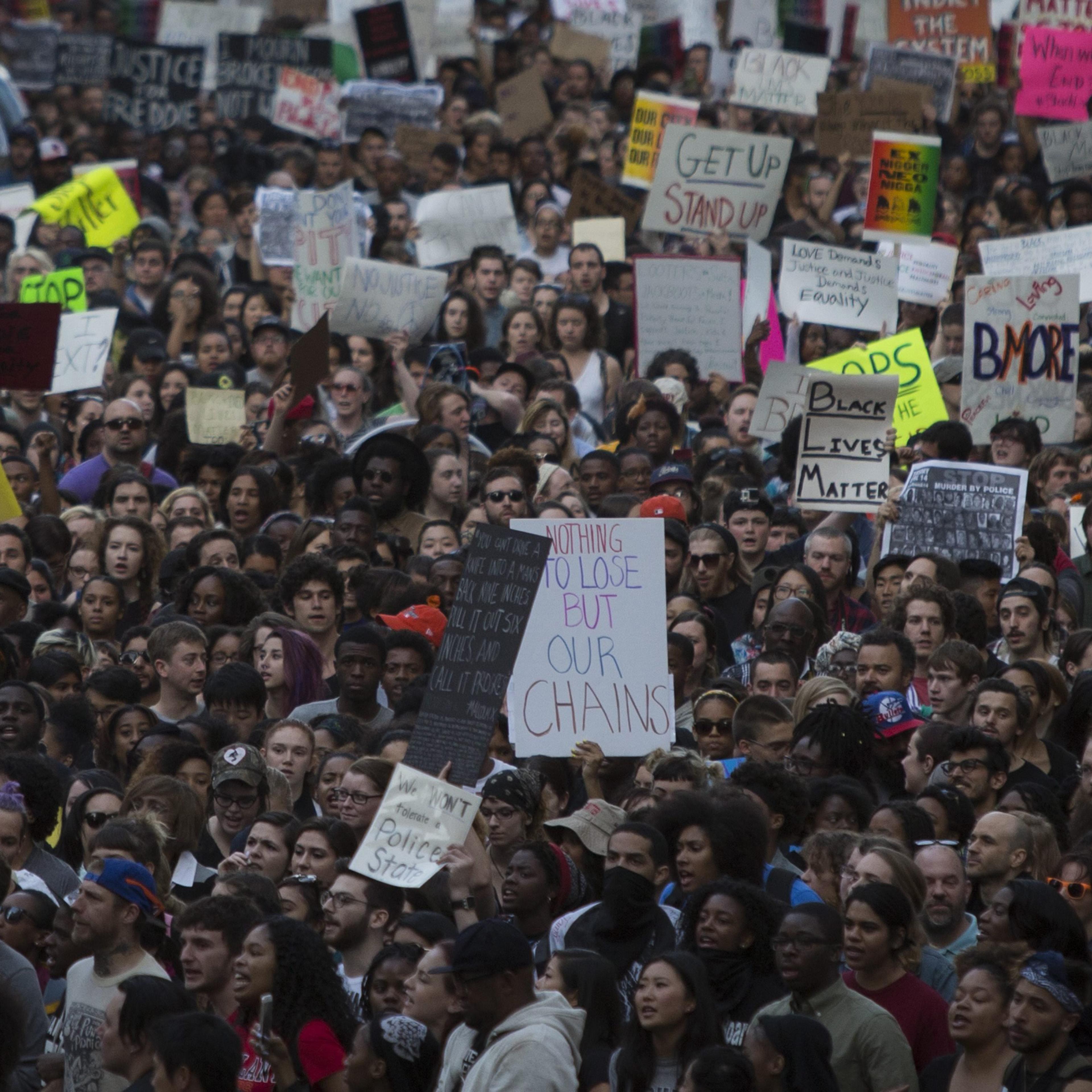 Protesters march near City Hall in Baltimore, on April 29, 2015, demonstrating against the death of Freddie Gray.