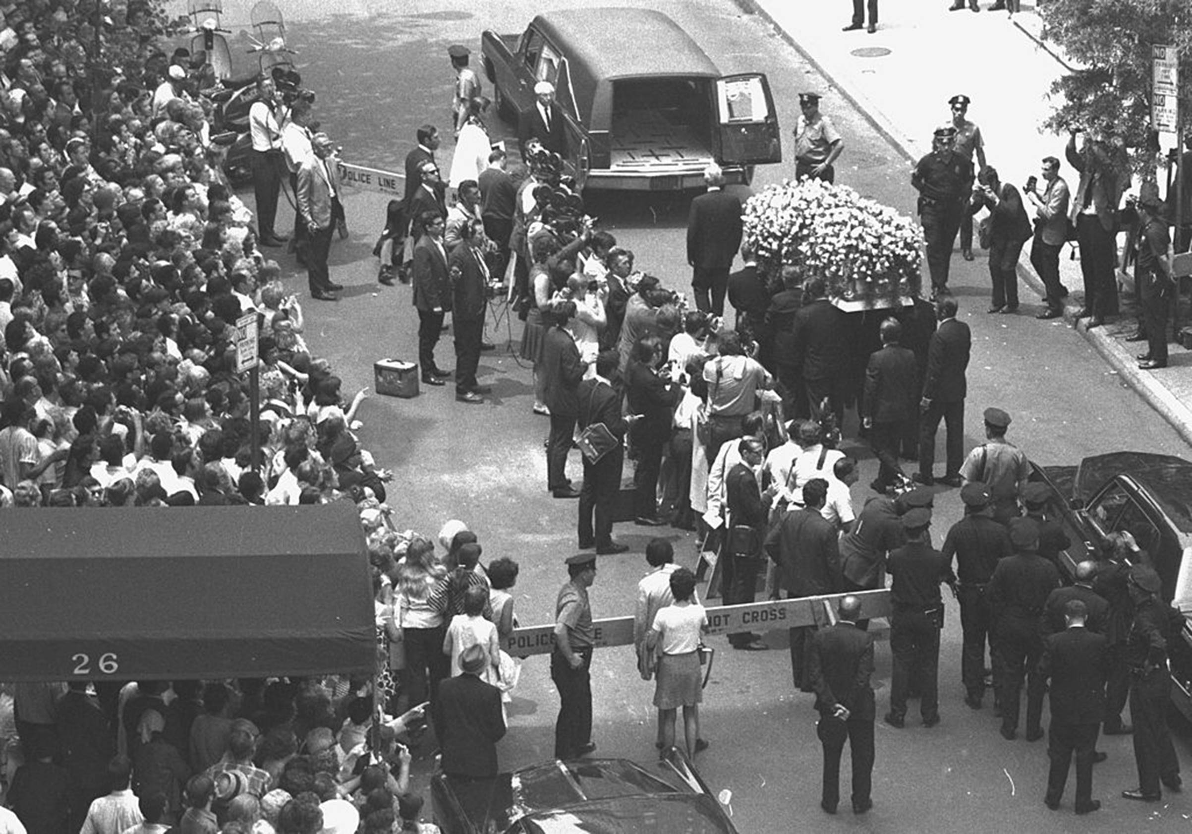 Yellow roses cover Judy Garland's coffin as it is taken to hearse at Campbell Funeral Home on June 27, 1969.