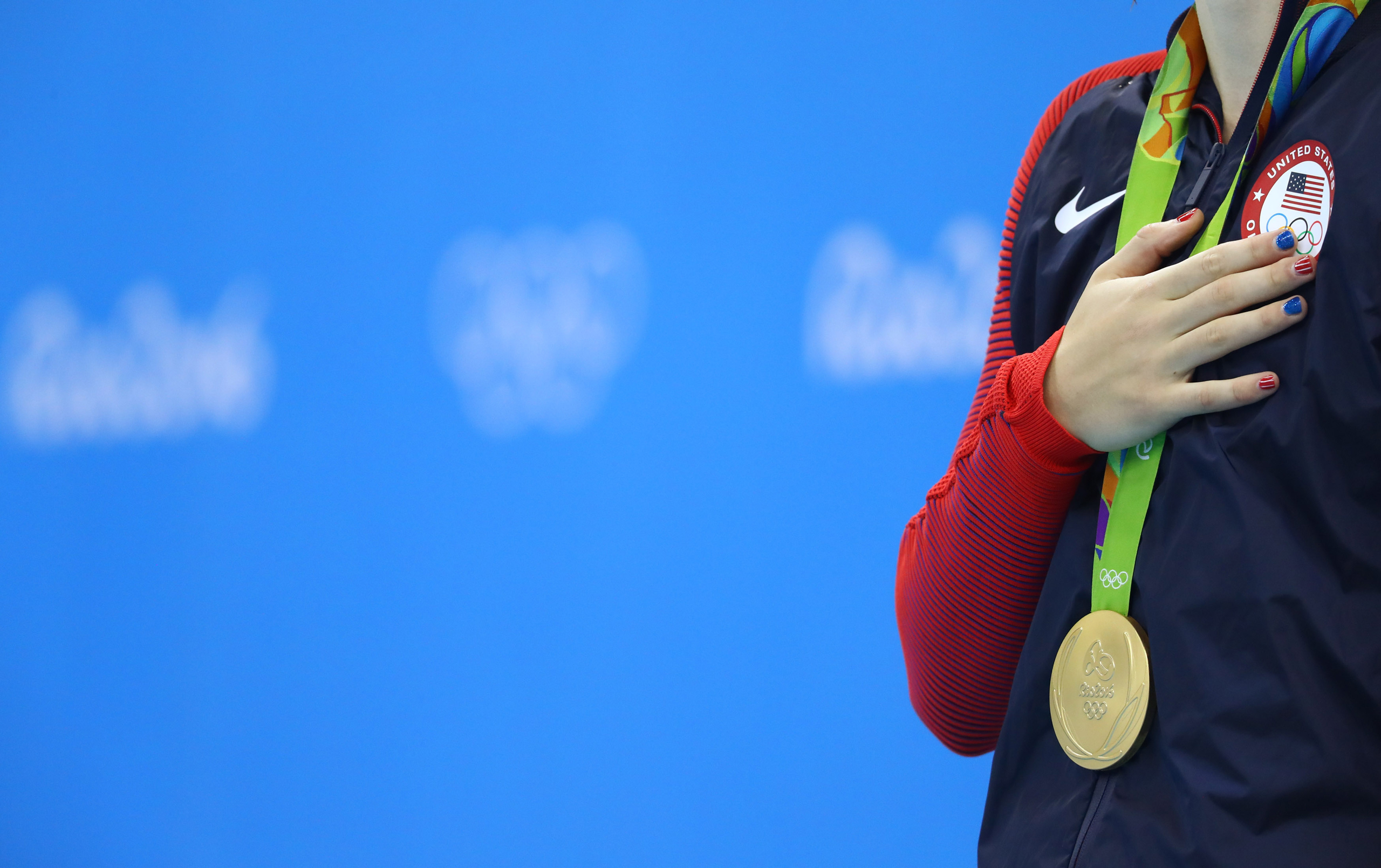 2016 Rio Olympics - Swimming - Victory Ceremony - Women's 200m Freestyle Victory Ceremony - Olympic Aquatics Stadium - Rio de Janeiro, Brazil - 09/08/2016. Katie Ledecky (USA) of USA stands to attention during the national anthem after winning the gold m