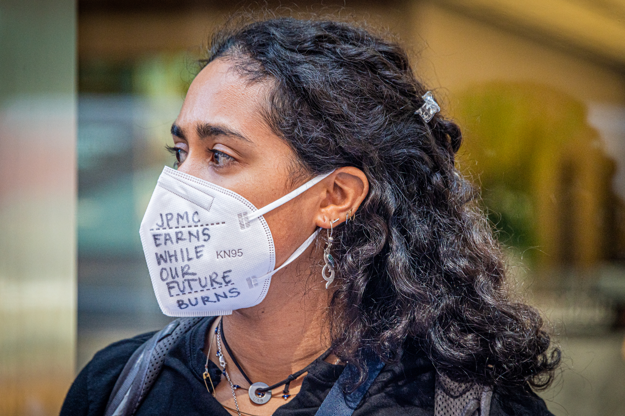 NYC: A climate activist wearing a mask at a rally outside the JPMorgan headquarters at JPMorgan Annual Shareholder Meeting
