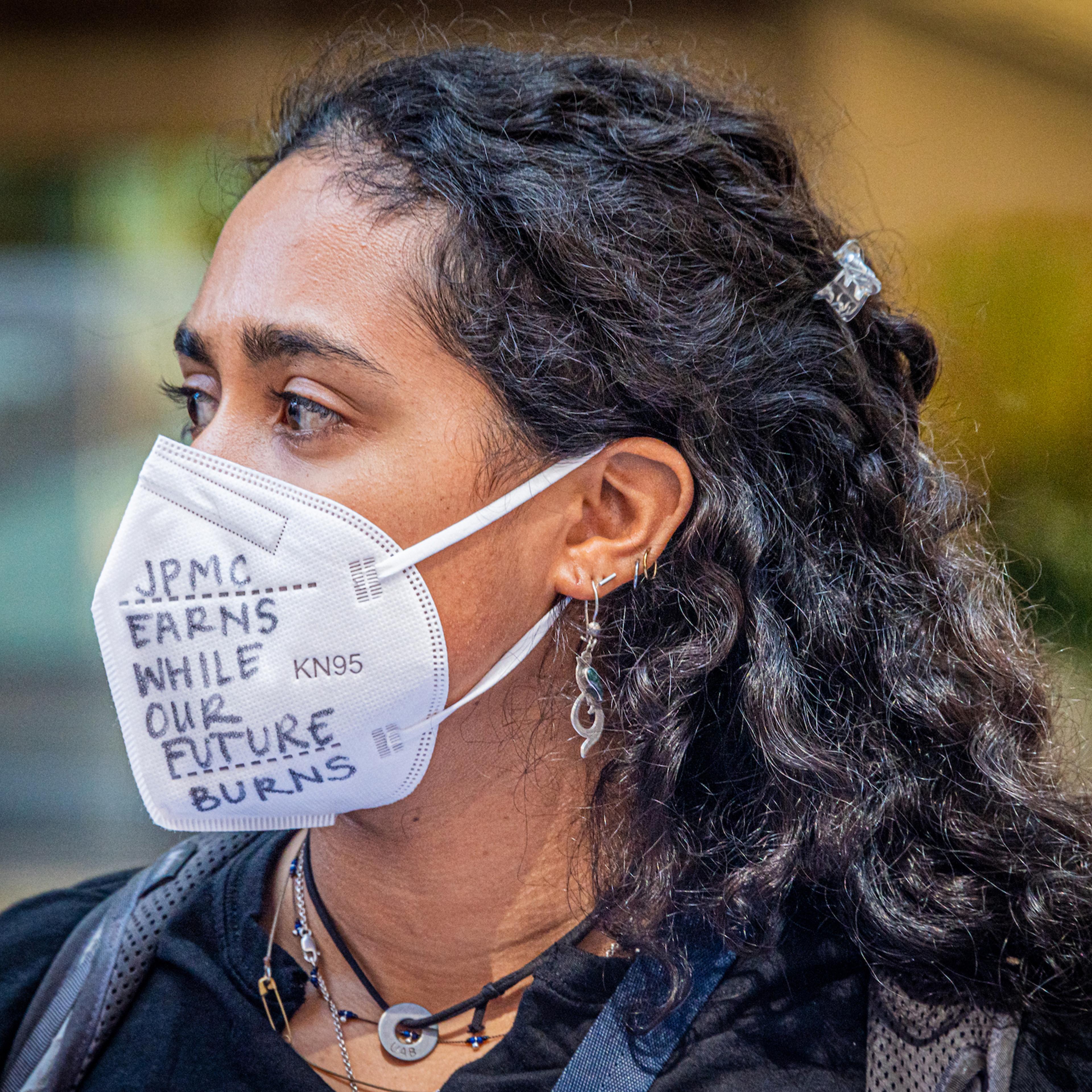 NYC: A climate activist wearing a mask at a rally outside the JPMorgan headquarters at JPMorgan Annual Shareholder Meeting