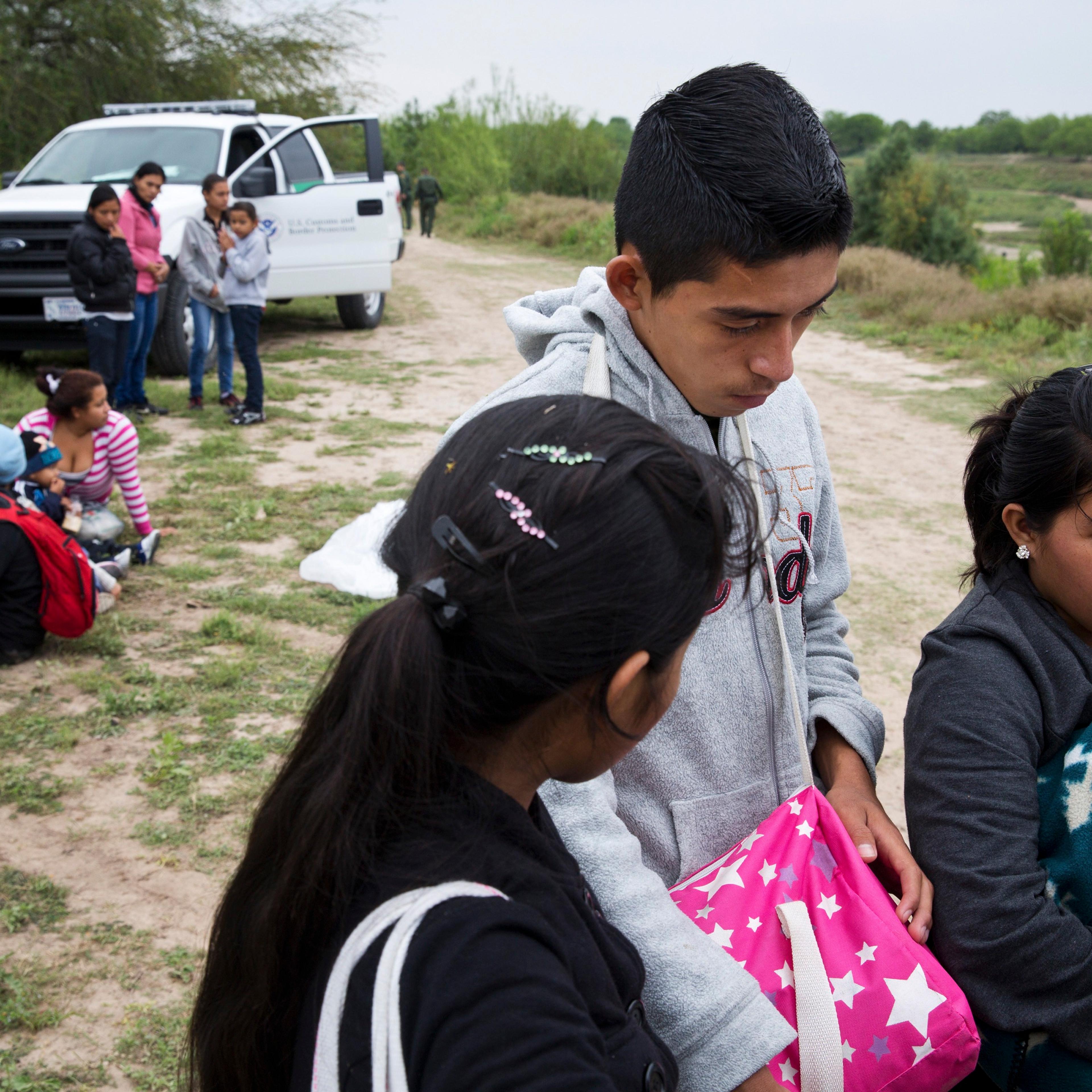 U.S. Border Patrol agents detain a group of young migrants from Honduras and Guatemala near the Anzalduas Dam.