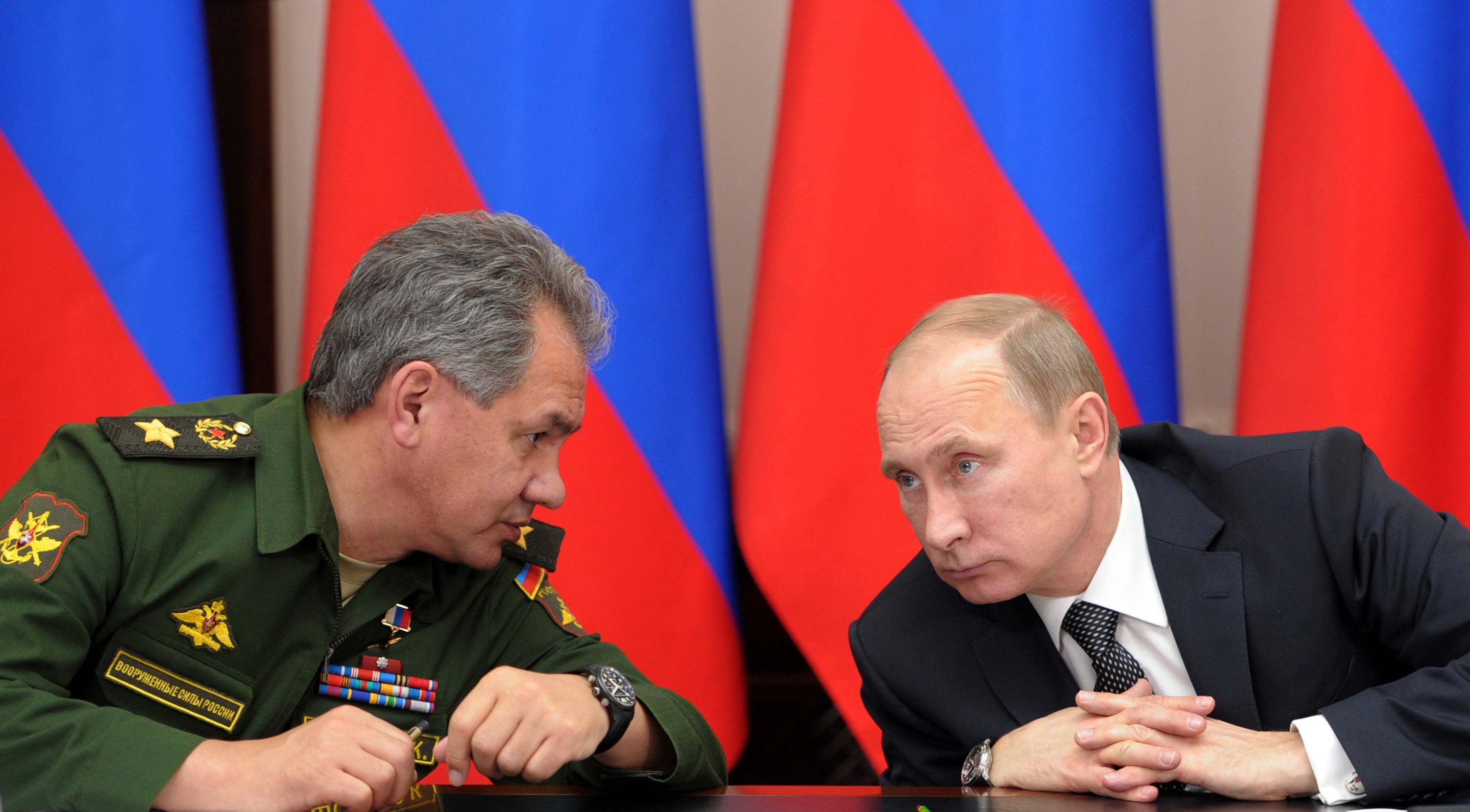 FILE - In this Friday, Nov. 15, 2013 file photo Russian President Vladimir Putin, right, and Defense Minister Sergei Shoigu attend a meeting while visiting the airborne troops school in the city of Ryazan, some 100 km (62.5 miles) southeast of Moscow, Ru