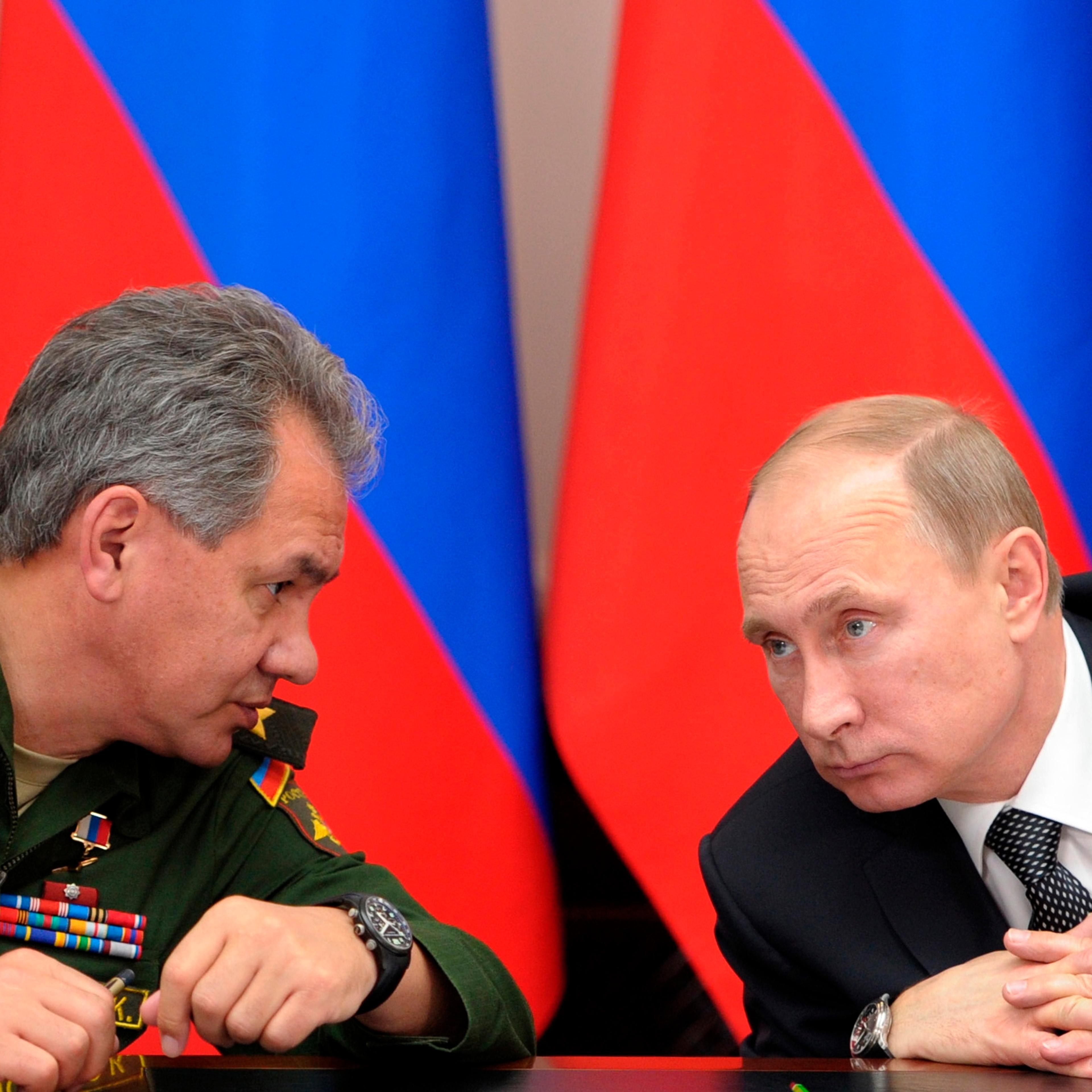 FILE - In this Friday, Nov. 15, 2013 file photo Russian President Vladimir Putin, right, and Defense Minister Sergei Shoigu attend a meeting while visiting the airborne troops school in the city of Ryazan, some 100 km (62.5 miles) southeast of Moscow, Ru