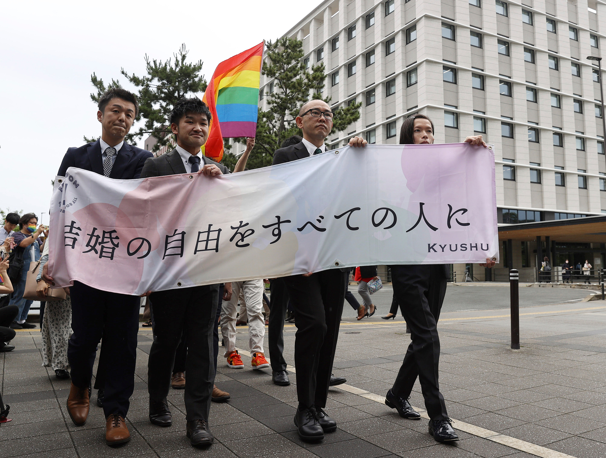 Plaintiffs head to the court for the same-gender marriage lawsuit at the Fukuoka District Court on June 8, holding a banner that reads "Marriage freedom for all." 