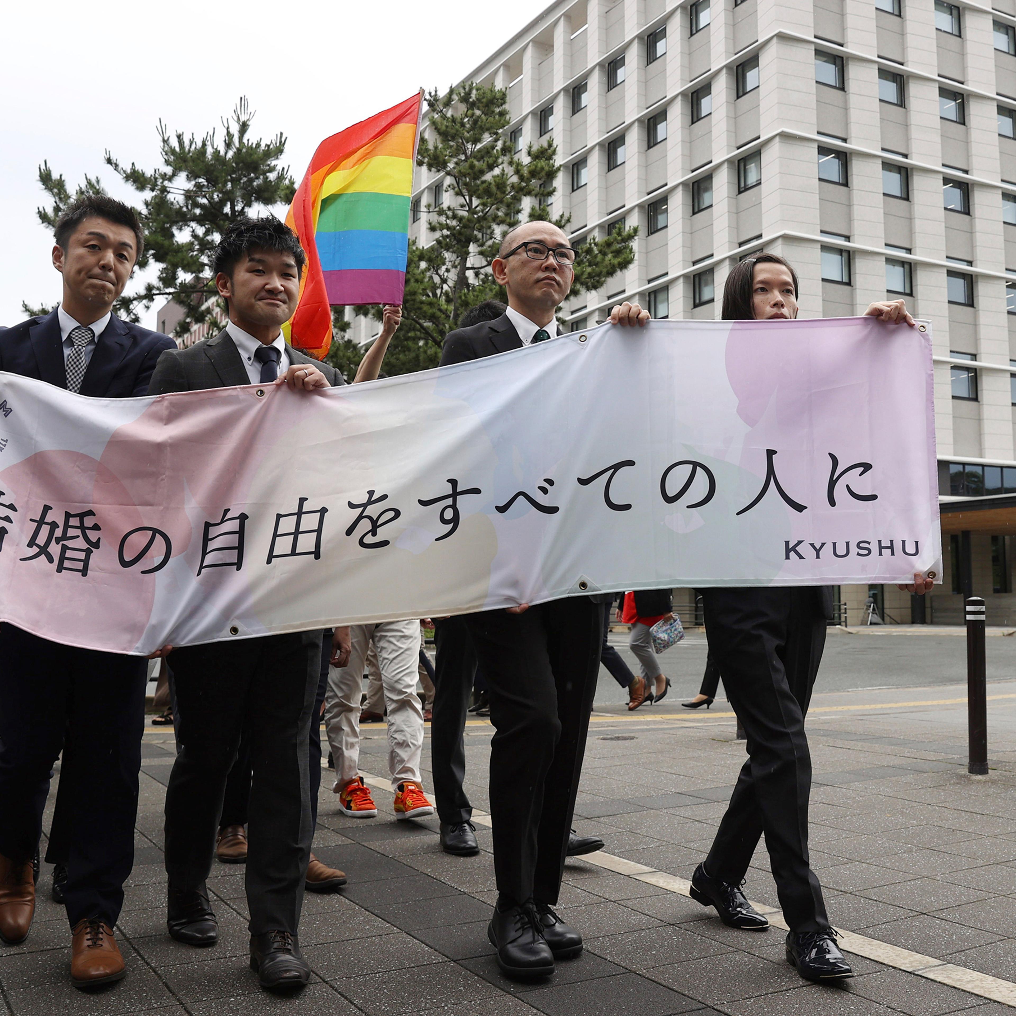 Plaintiffs head to the court for the same-gender marriage lawsuit at the Fukuoka District Court on June 8, holding a banner that reads "Marriage freedom for all."
