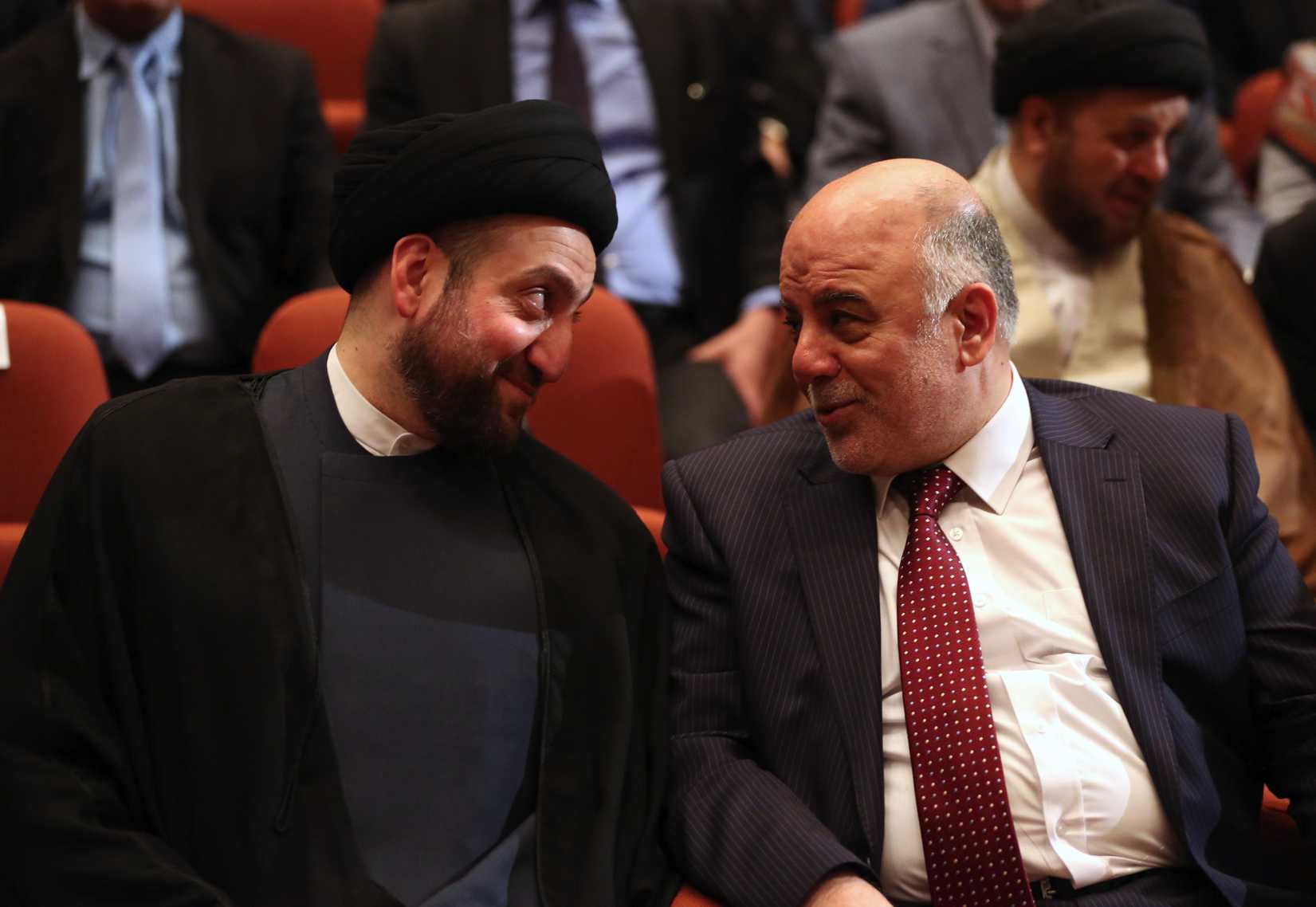 Iraq's new Prime Minister Haider al-Abadi, right, and Ammar al-Hakim, left, the leader of the Supreme Islamic Council of Iraq, during the session to approve the new government in Baghdad on Sept. 8, 2014 