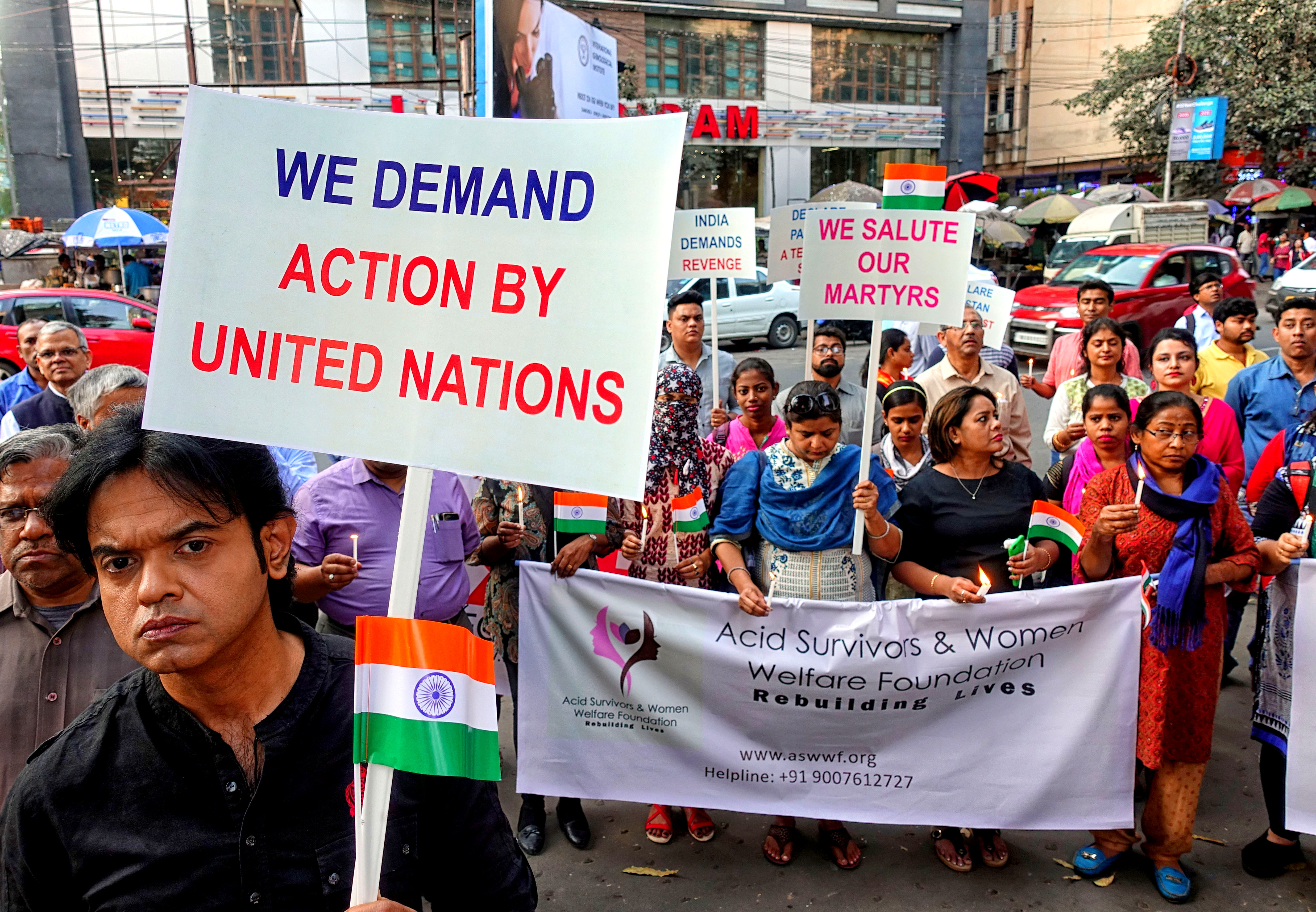 Demonstrators seen holding several placards and a large