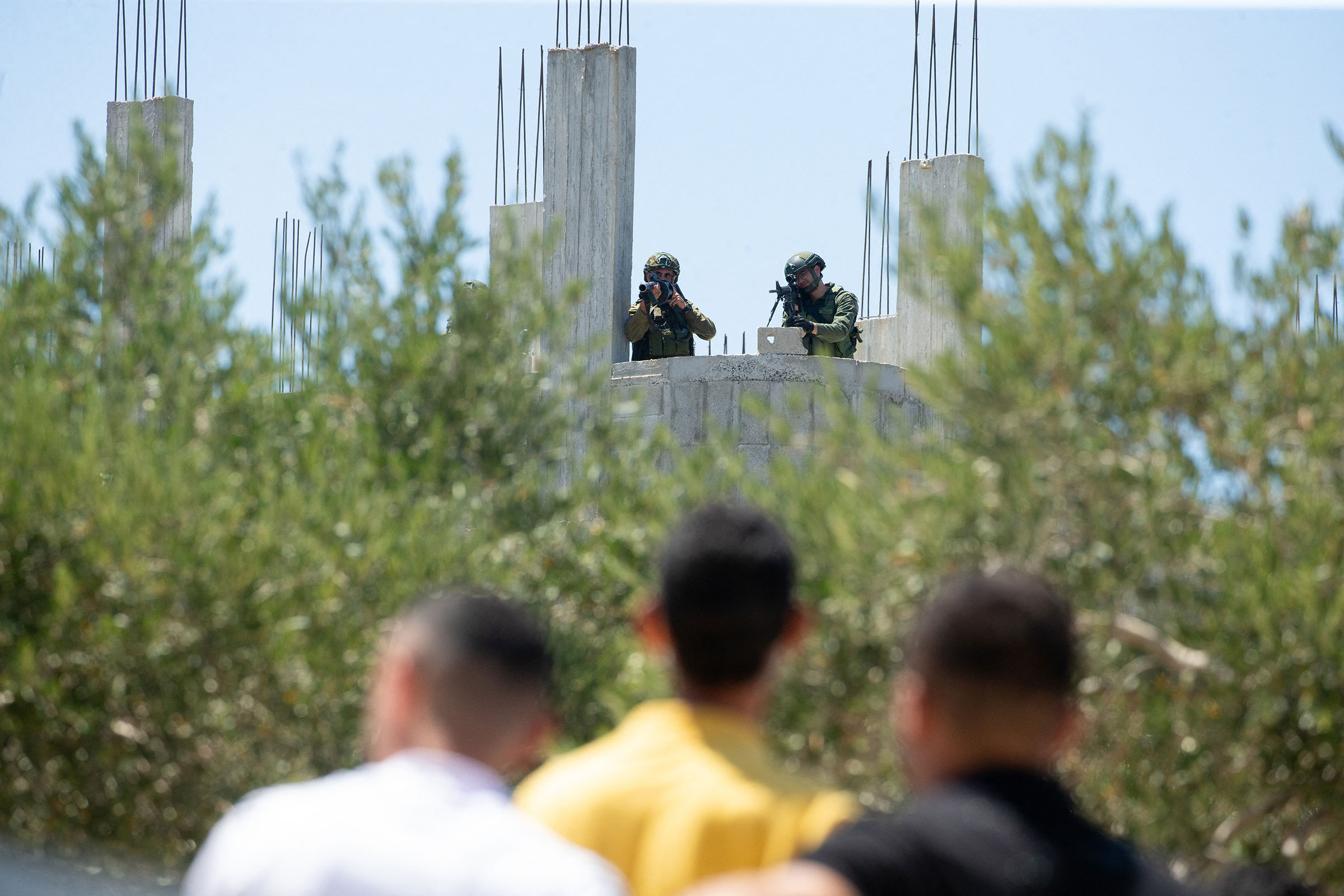 Israeli soldiers face Palestinian protesters in the town of Beita, in West Bank on Aug. 9, 2024.