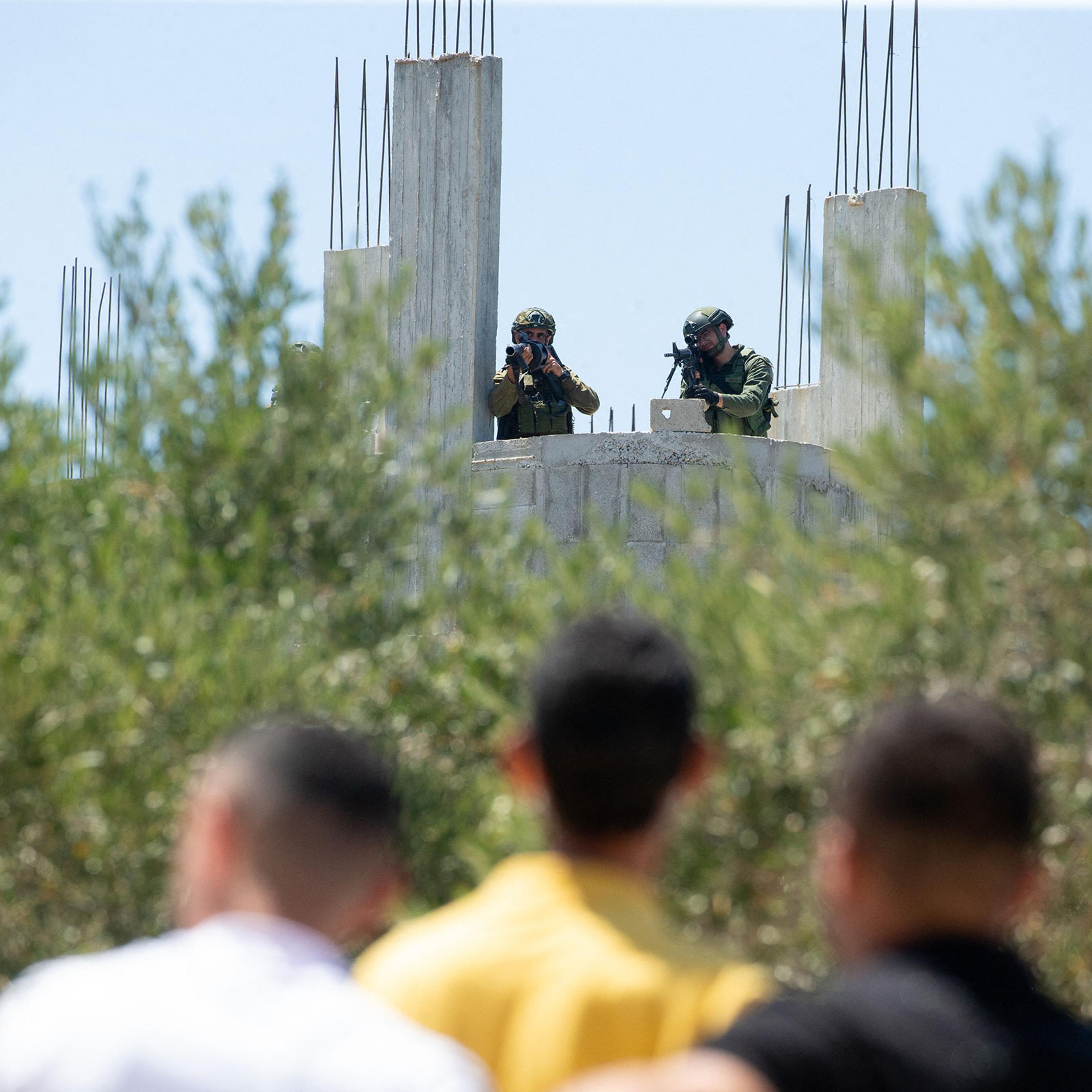 Israeli soldiers face Palestinian protesters in the town of Beita, in West Bank on Aug. 9, 2024.