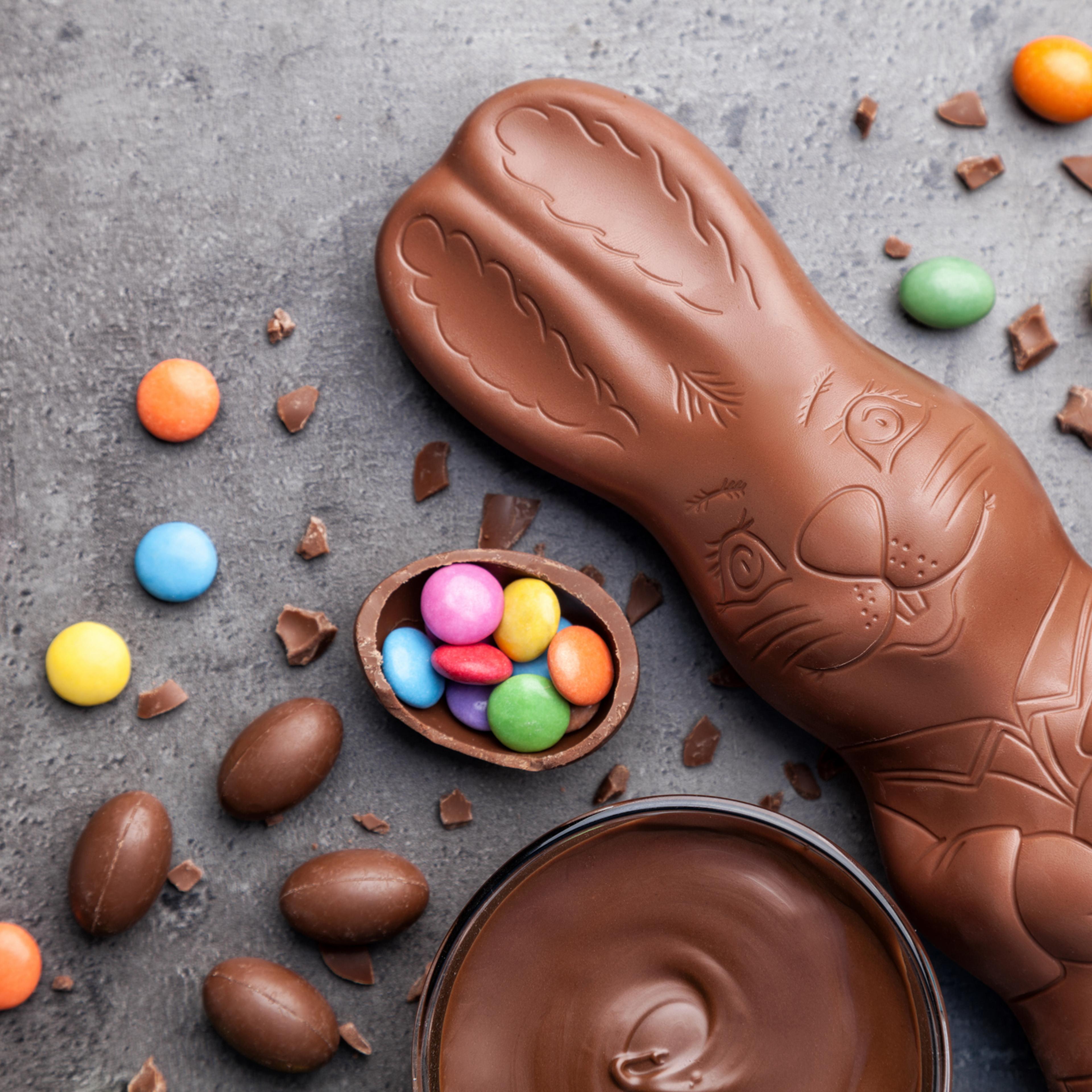 Chocolate Easter bunny and eggs on rustic background