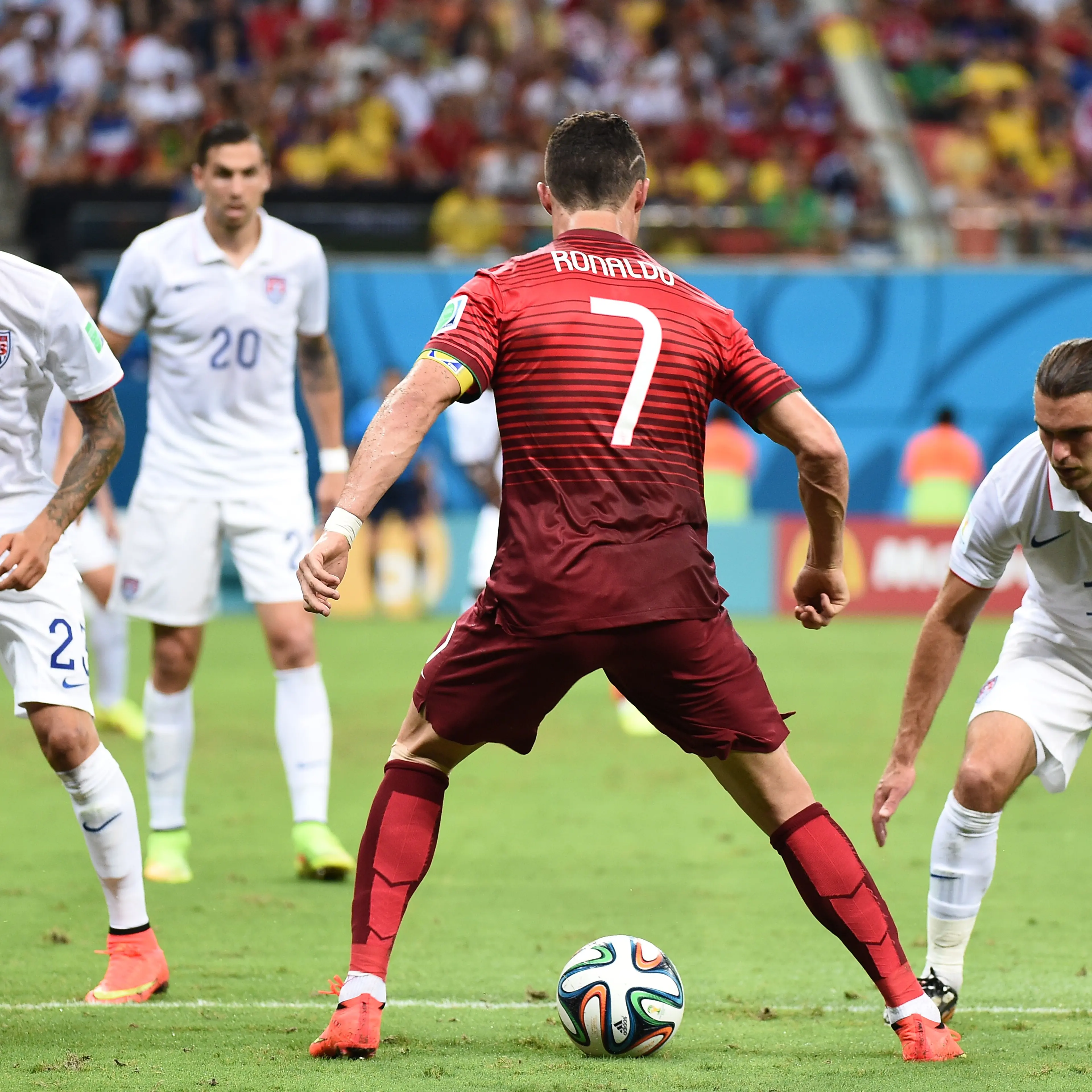 U.S. midfielder Graham Zusi (right) and US defender Fabian Johnson (left) defend against Portugal's forward Cristiano Ronaldo (second from right) during a Group G match between USA and Portugal at the Amazonia Arena in Manaus during the 2014 FIFA World C