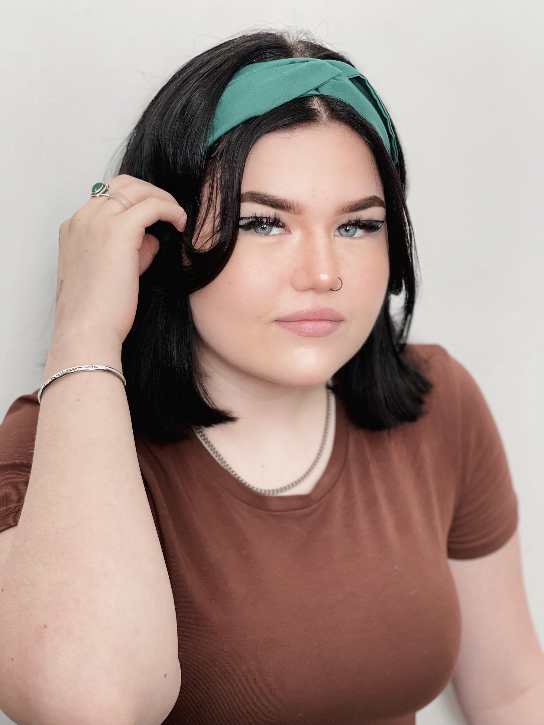 Mae Stephens tucking her hair behind her ear