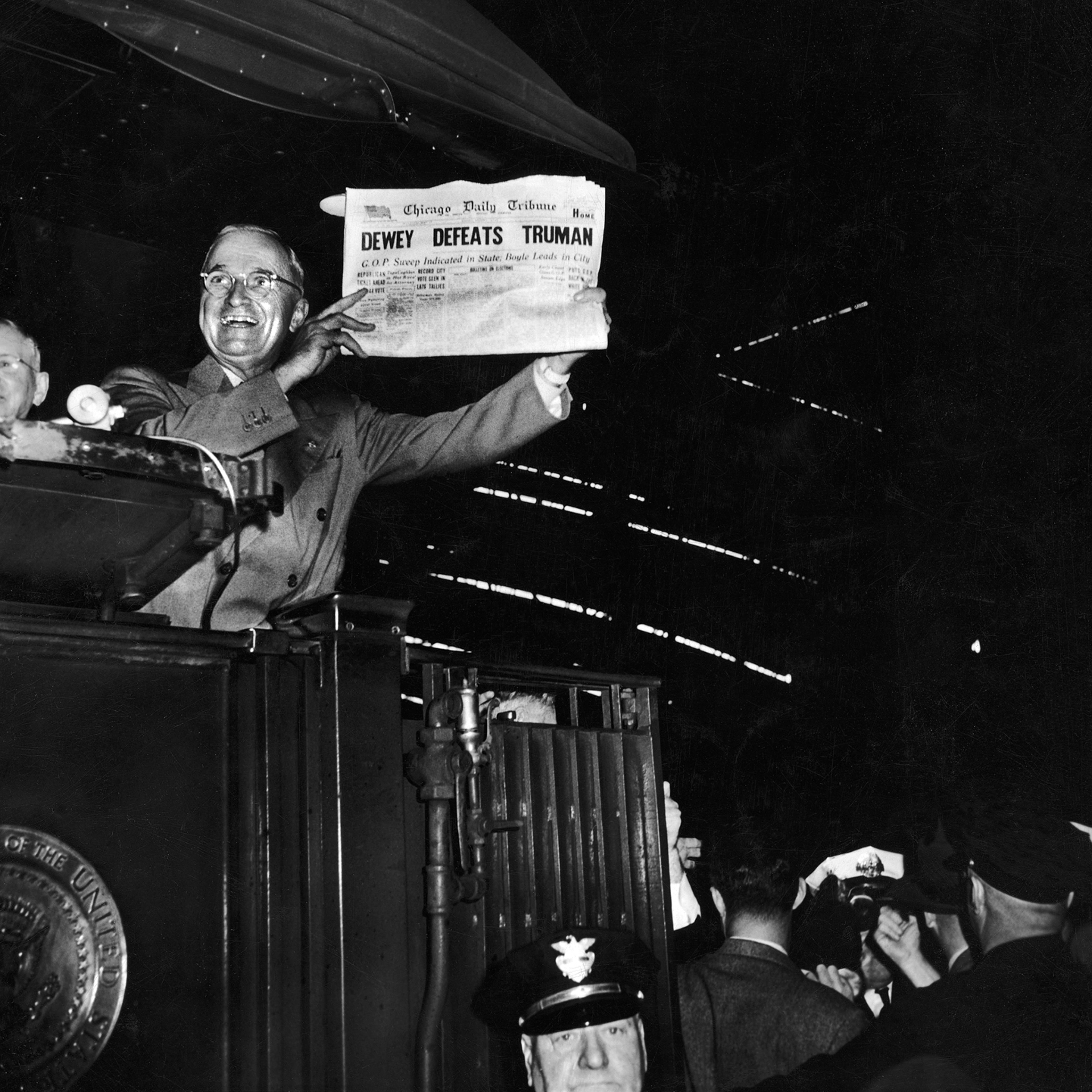 President Harry Truman jubilantly holds up a Chicago newspaper emblazoned with the (erroneous) headline, DEWEY DEFEATS TRUMAN. In fact, Truman handily beat New York governor Thomas Dewey in the tight 1948 presidential election.