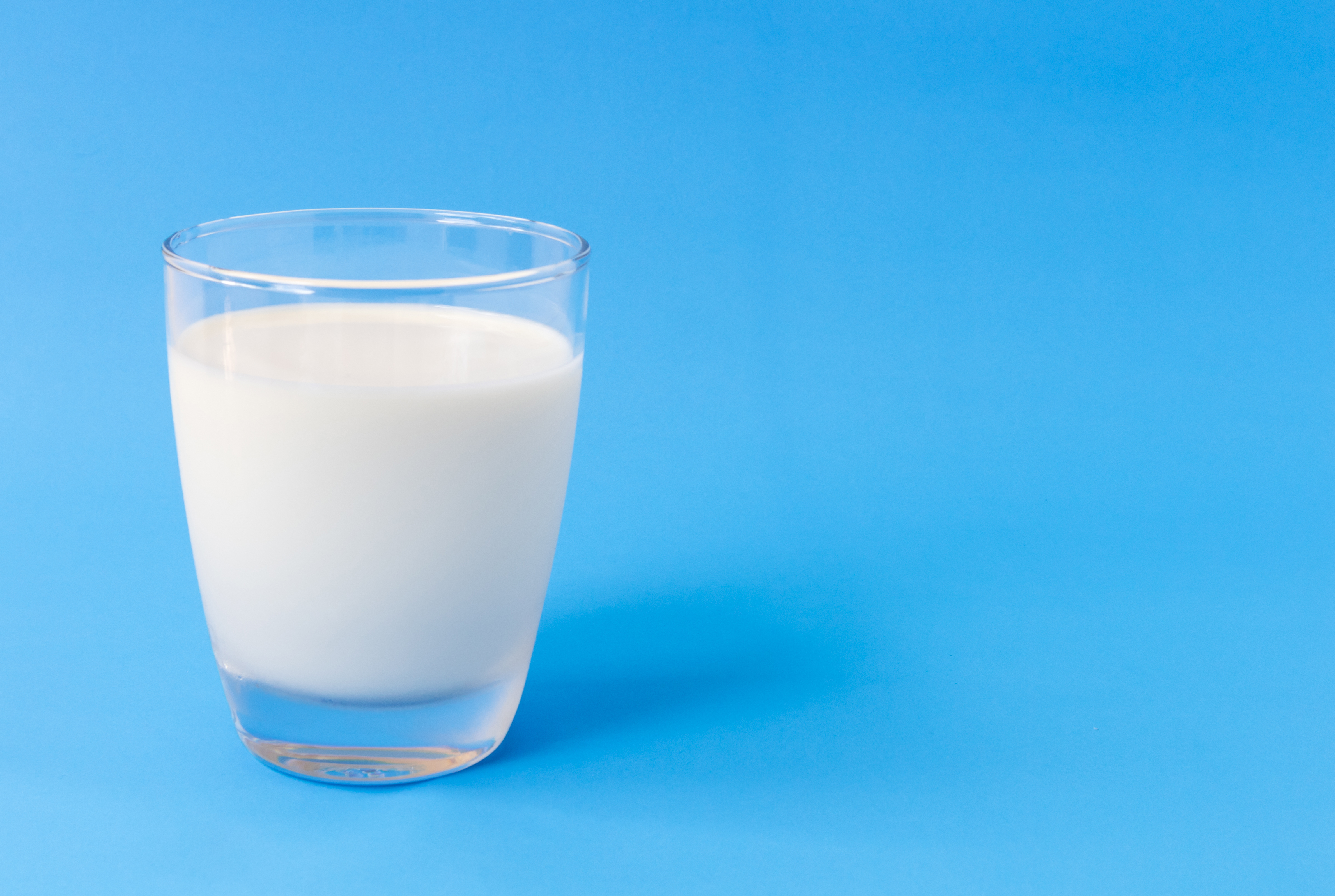 Close-Up Of Milk Against Blue Background