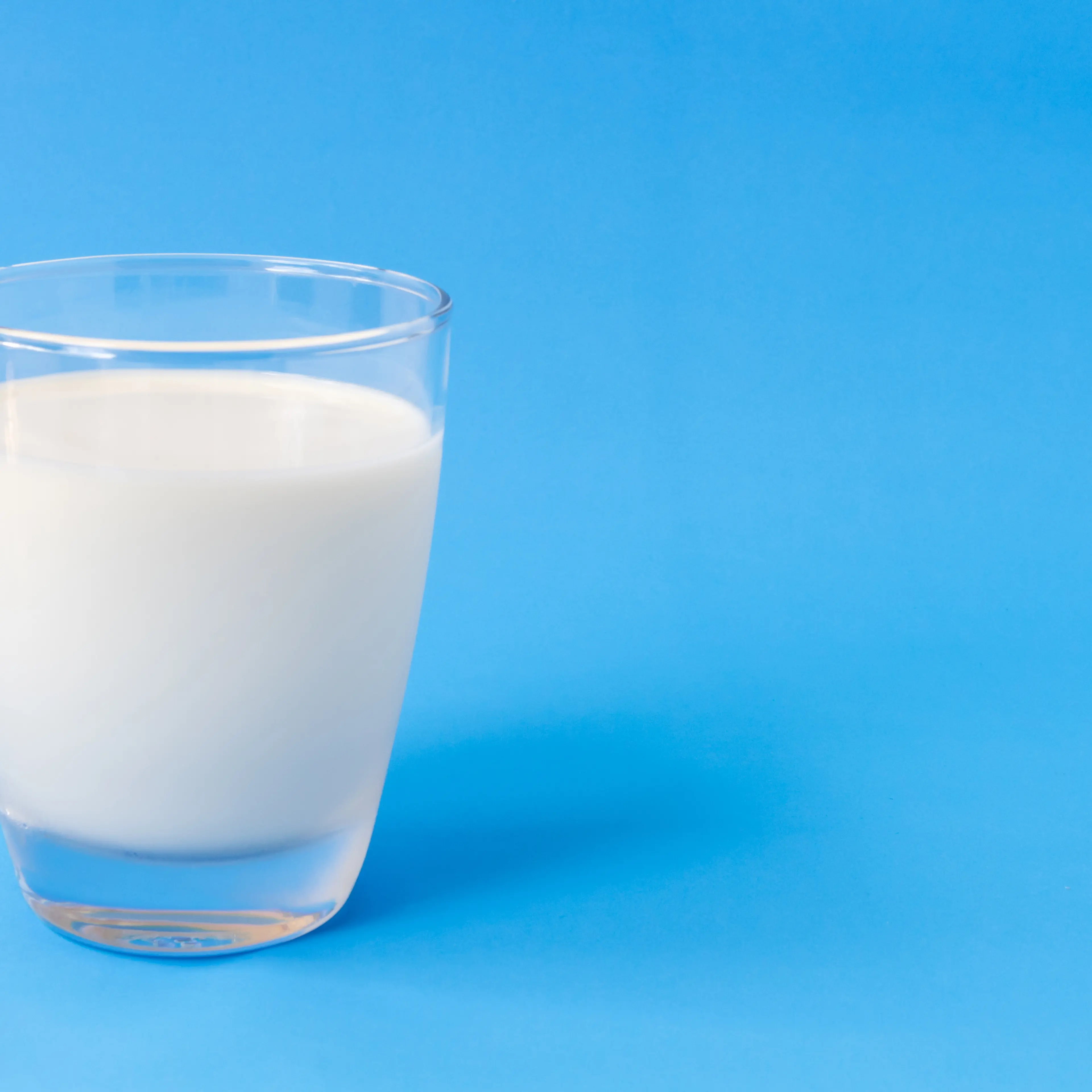 Close-Up Of Milk Against Blue Background