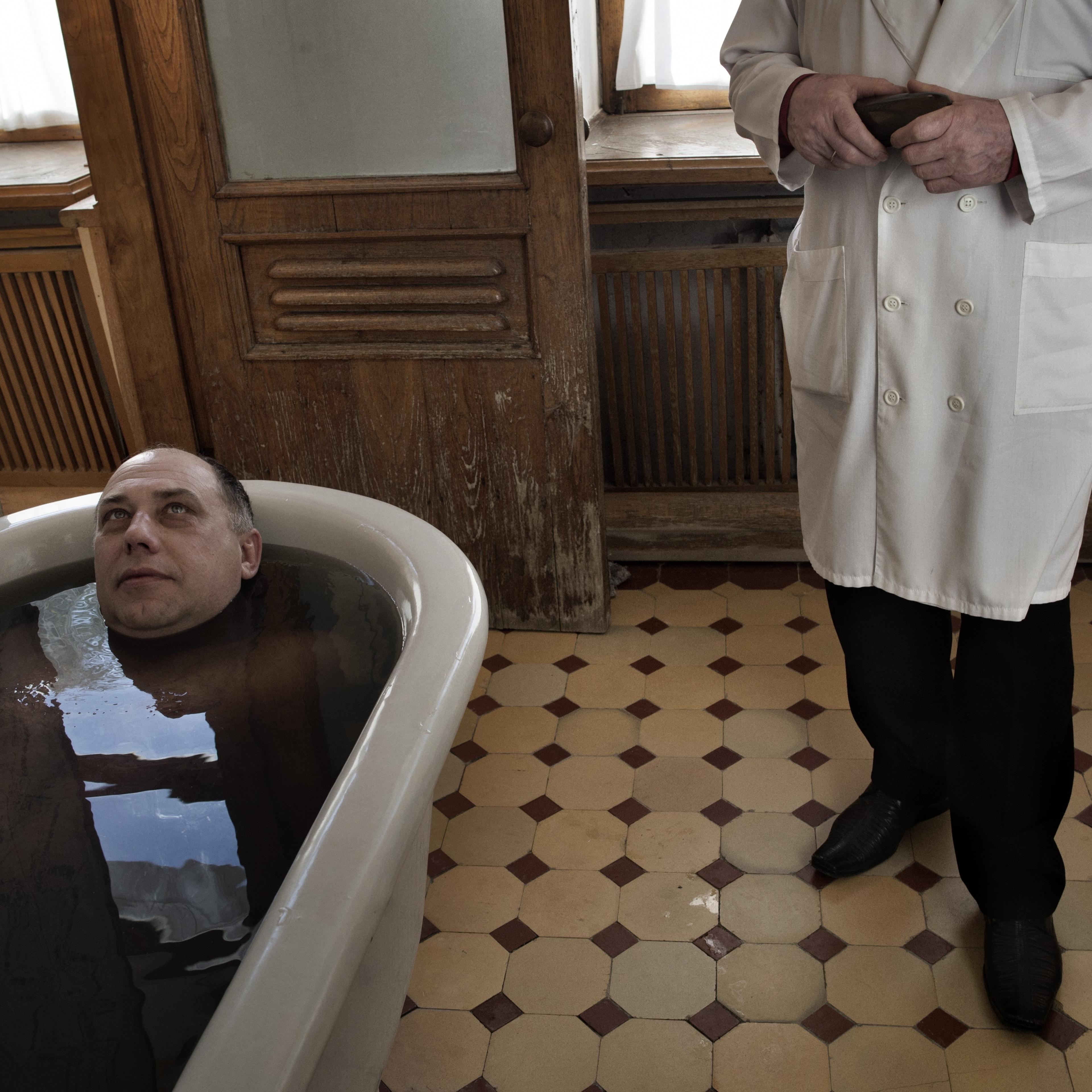 Sochi Russia January 15 2014 A patient during his mineral bath at the Matsesta Sanatorium in Sochi. Starting in the late 1930s, Matsesta was at the center of Josef Stalin's drive to turn Sochi into the premier resort city of the Soviet Union. Workers f