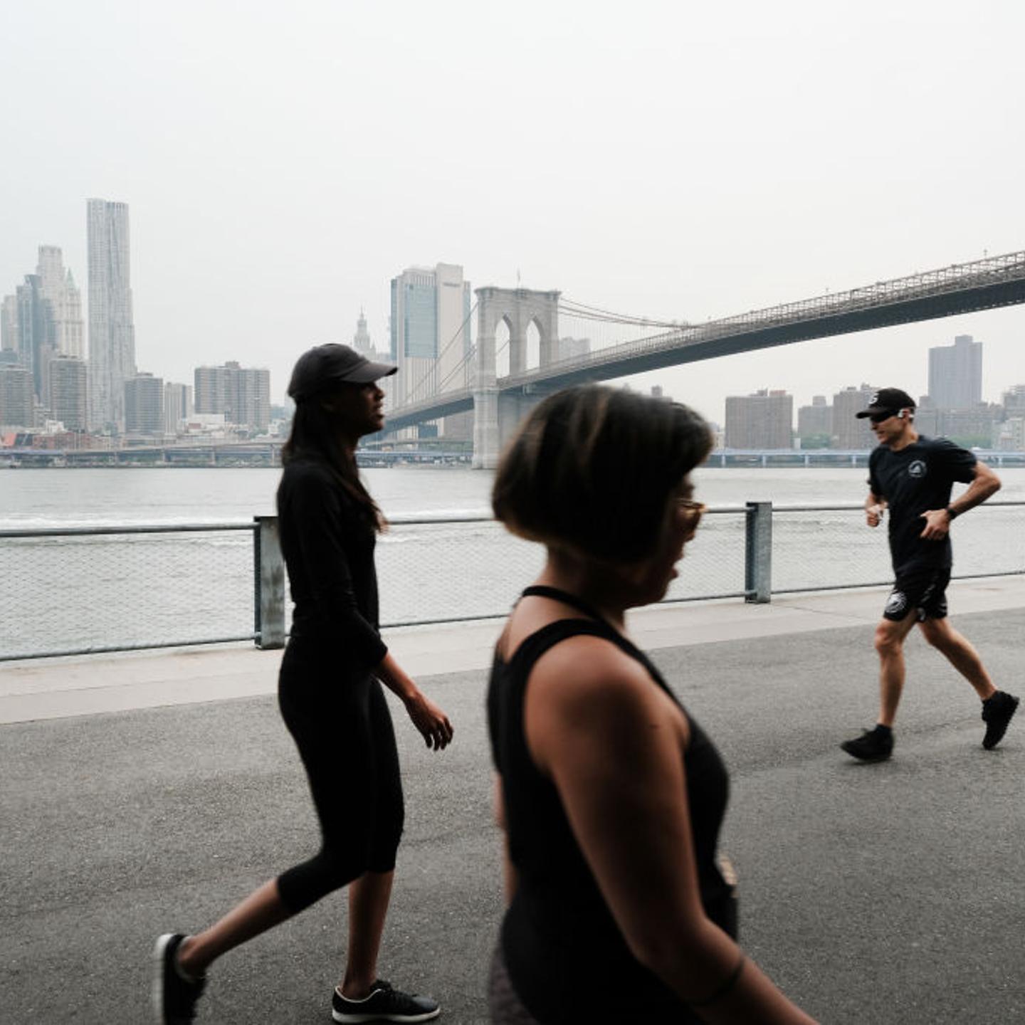 People walk through a Brooklyn Park on a hazy morning resulting from Canadian wildfires on June 6, 2023 in New York City. Over 100 wildfires are burning in the Canadian province of Nova Scotia and Quebec causing air quality health alerts for New York Sta