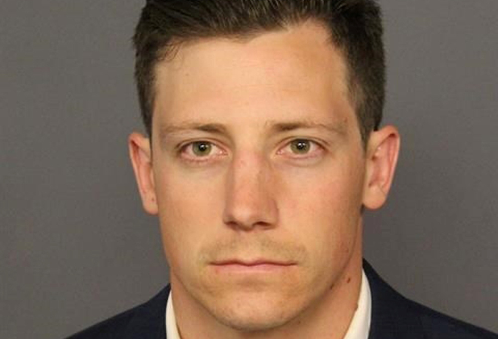 FBI agent Bishop appears in a booking photo in Denver