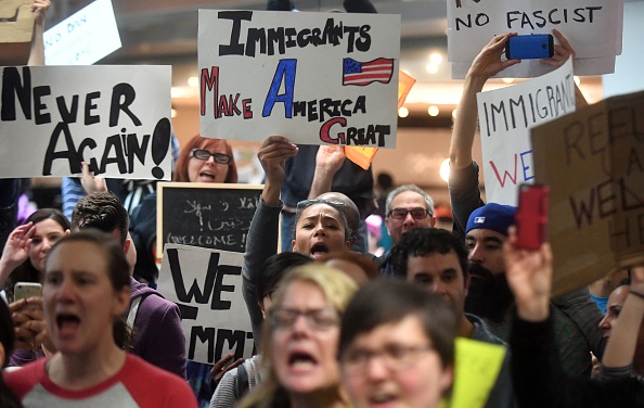Protesters shout and hold up signs at San Francisco International Airport in San Francisco, California on January 29, 2017.