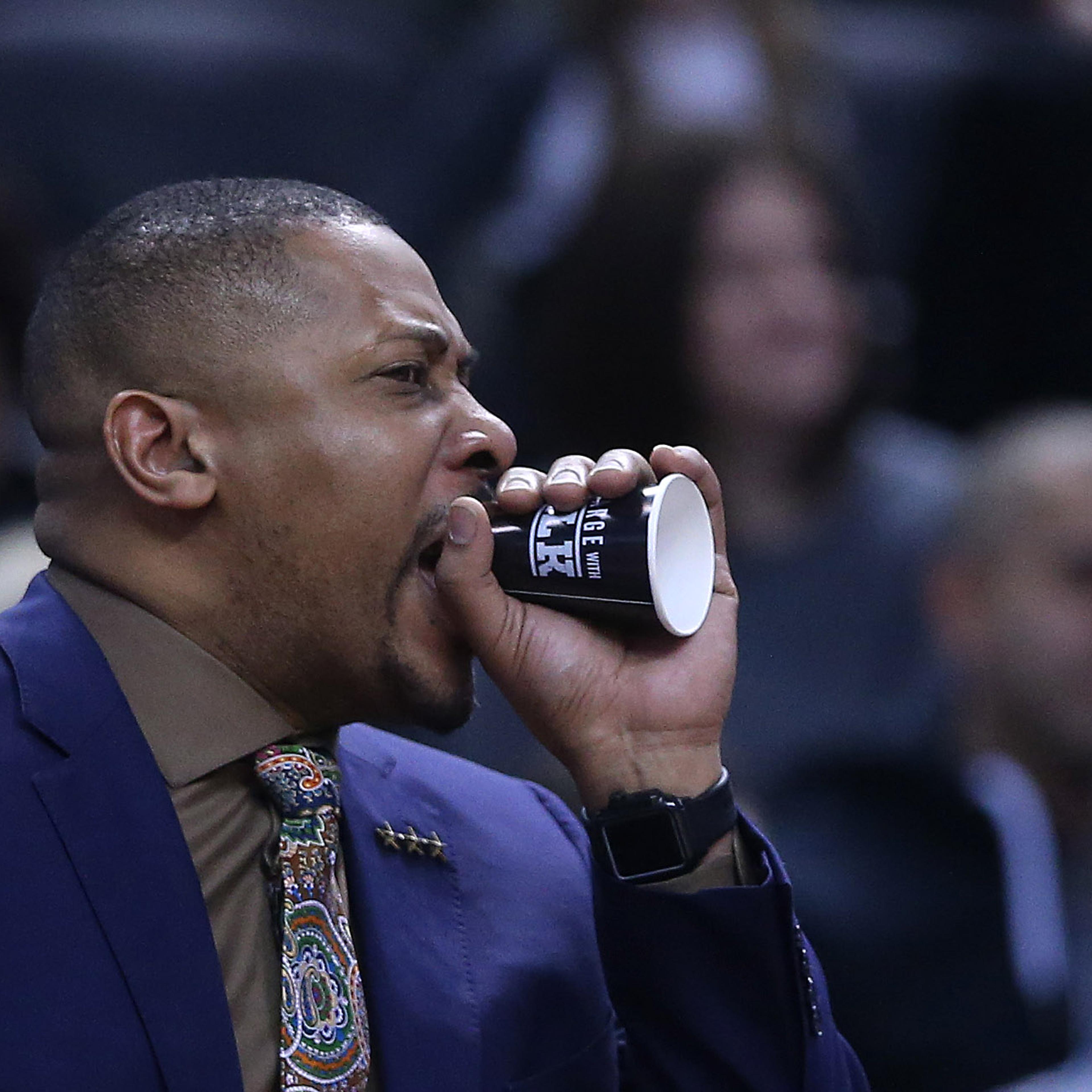 Toronto Raptors assistant coach Jamaal Magloire uses a paper cup as a megaphone to shout instructions to the defense at Scotiabank Arena in Toronto, March 24, 2019.