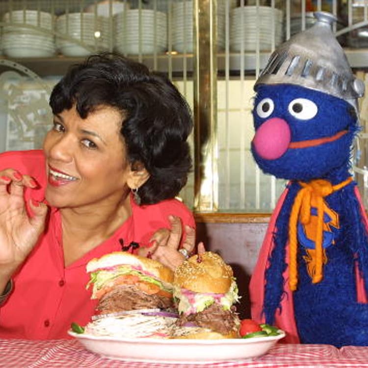 Sonia Manzano, who plays Maria Rodriquez on "Sesame Street," and the muppet Grover at an event in New York City on Feb. 27, 2002.