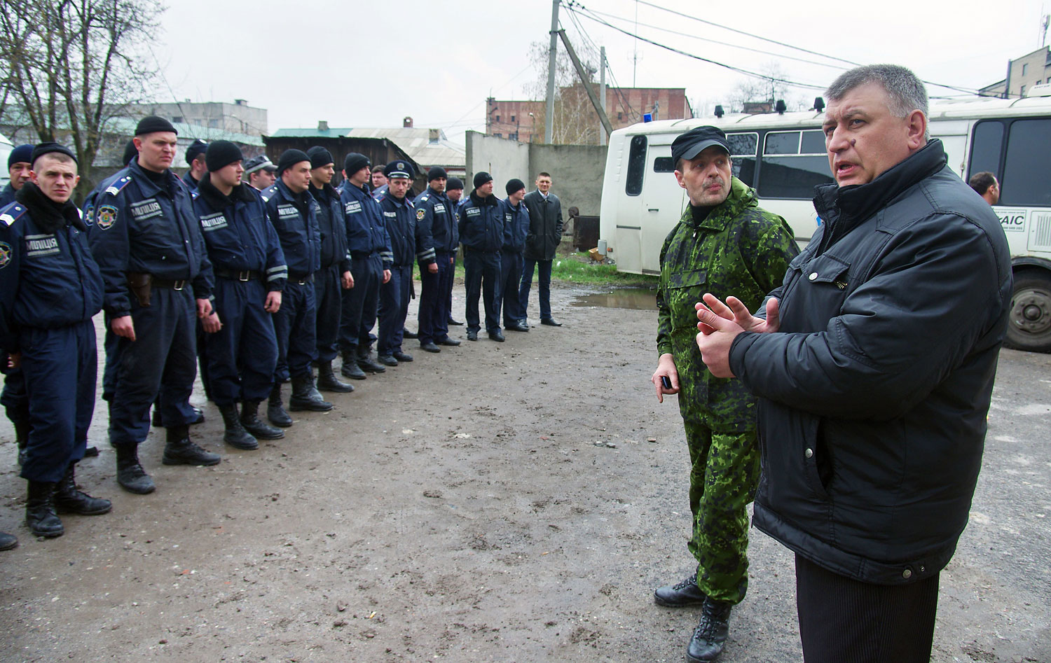 A man, who introduced himself as a lieutenant colonel of the Russian army, speaks to policemen as he introduces his appointed new head of the regional police, after the regional police building storm was stormed and its chief detained, in the eastern Ukr