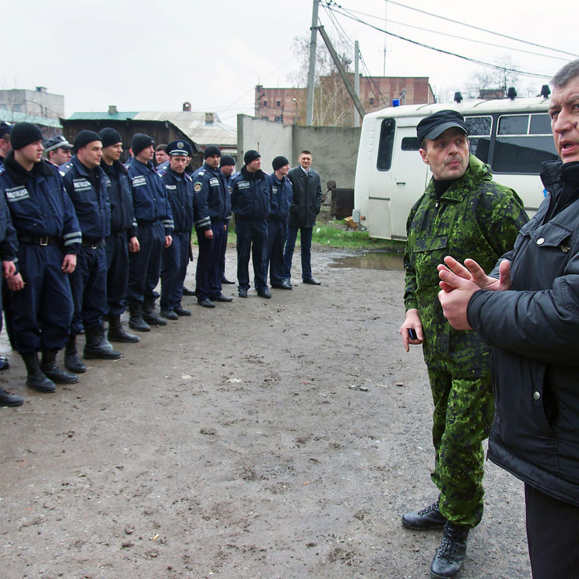 A man, who introduced himself as a lieutenant colonel of the Russian army, speaks to policemen as he introduces his appointed new head of the regional police, after the regional police building storm was stormed and its chief detained, in the eastern Ukr