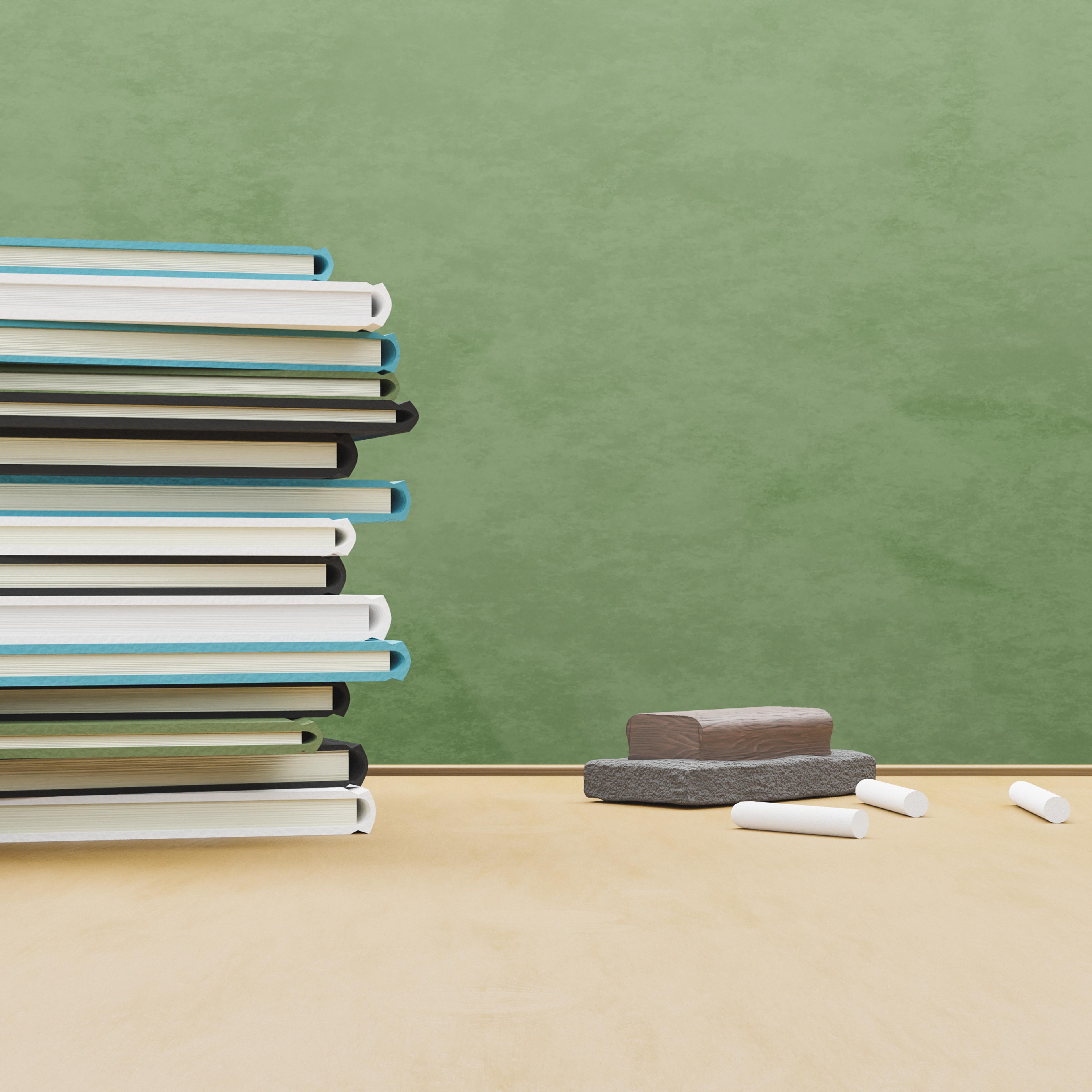 School table full of books with eraser and chalk,Romania