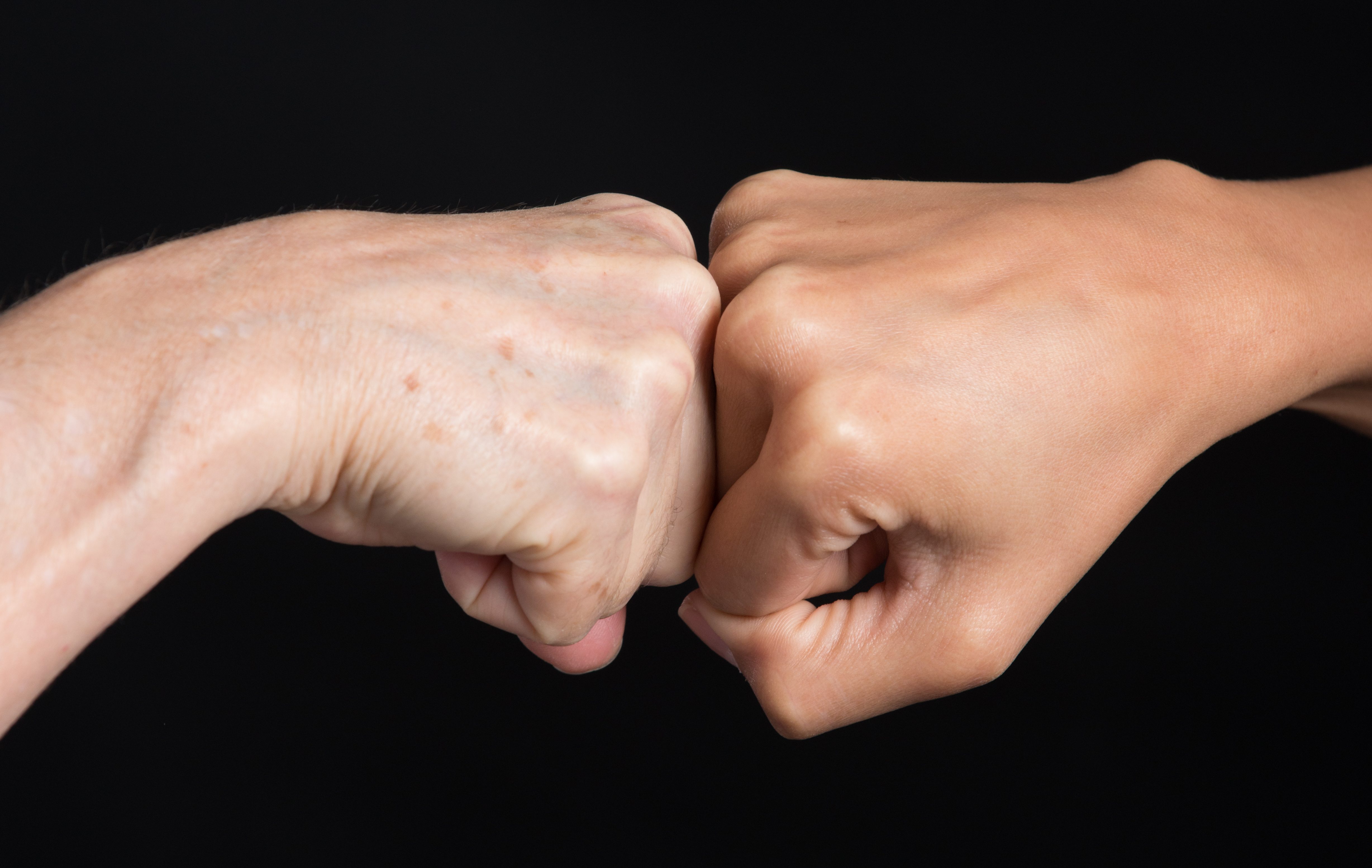 Fist-bump over Black Background