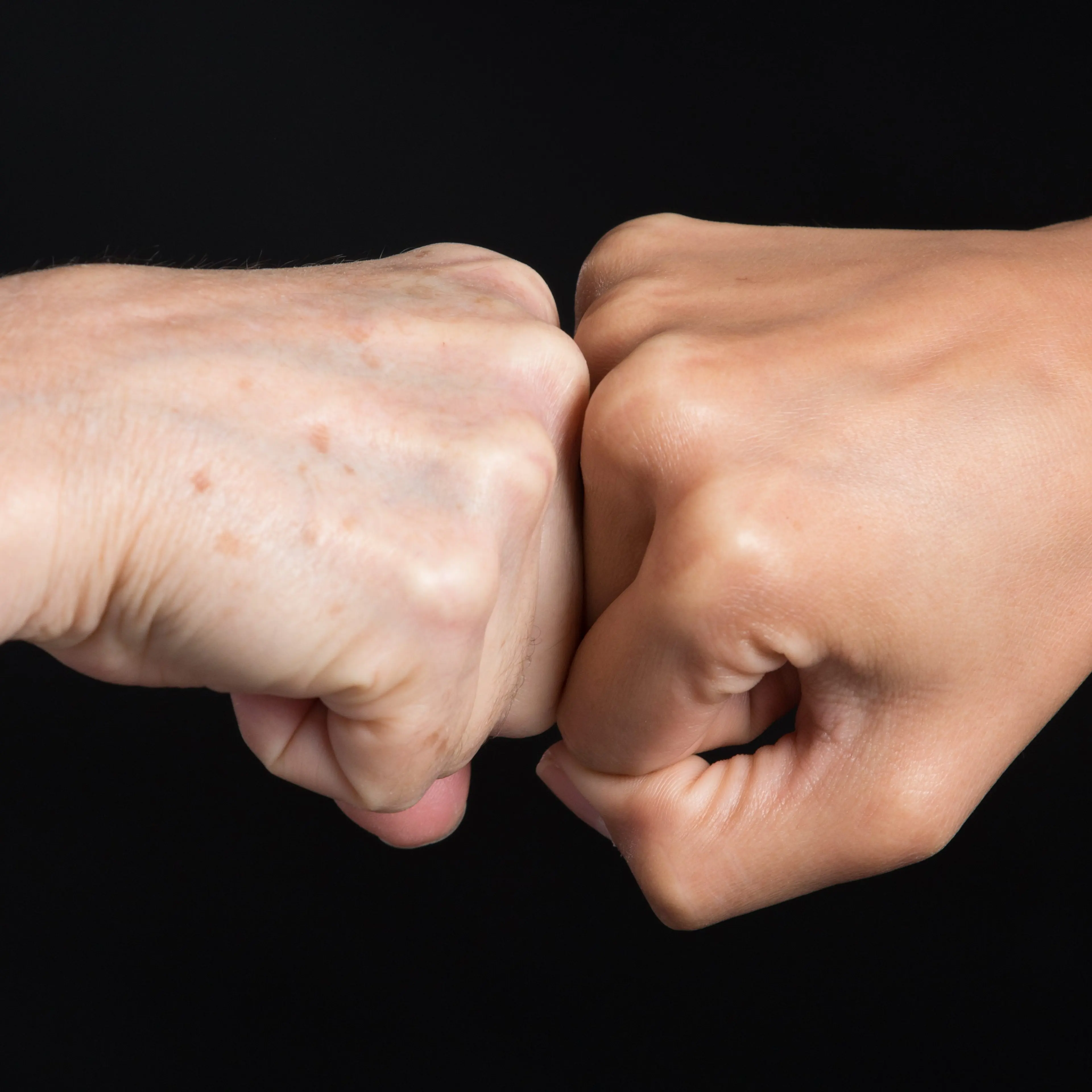 Fist-bump over Black Background