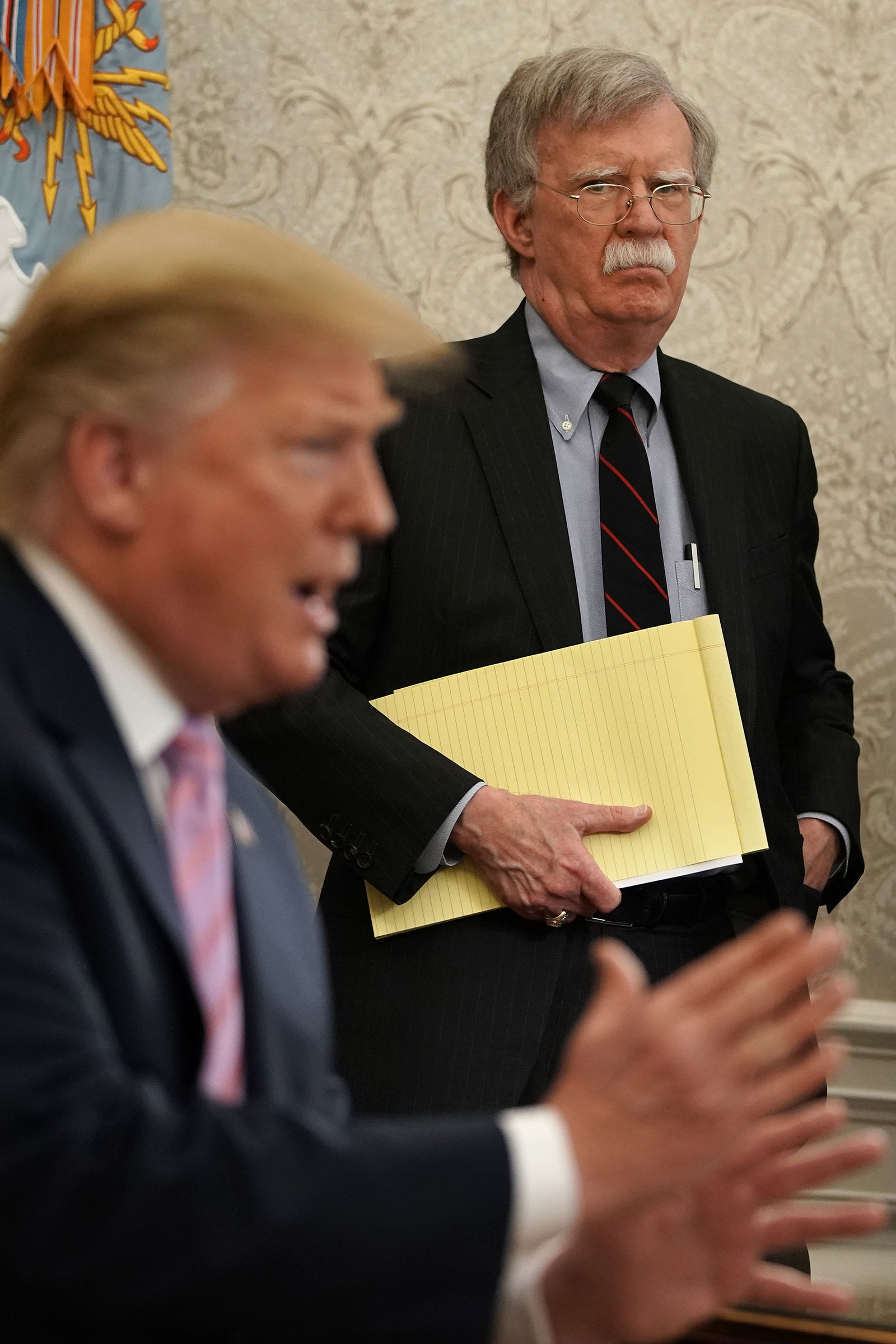 John Bolton, then National Security Advisor, listens to President Trump during an Oval Office meeting on April 9, 2019