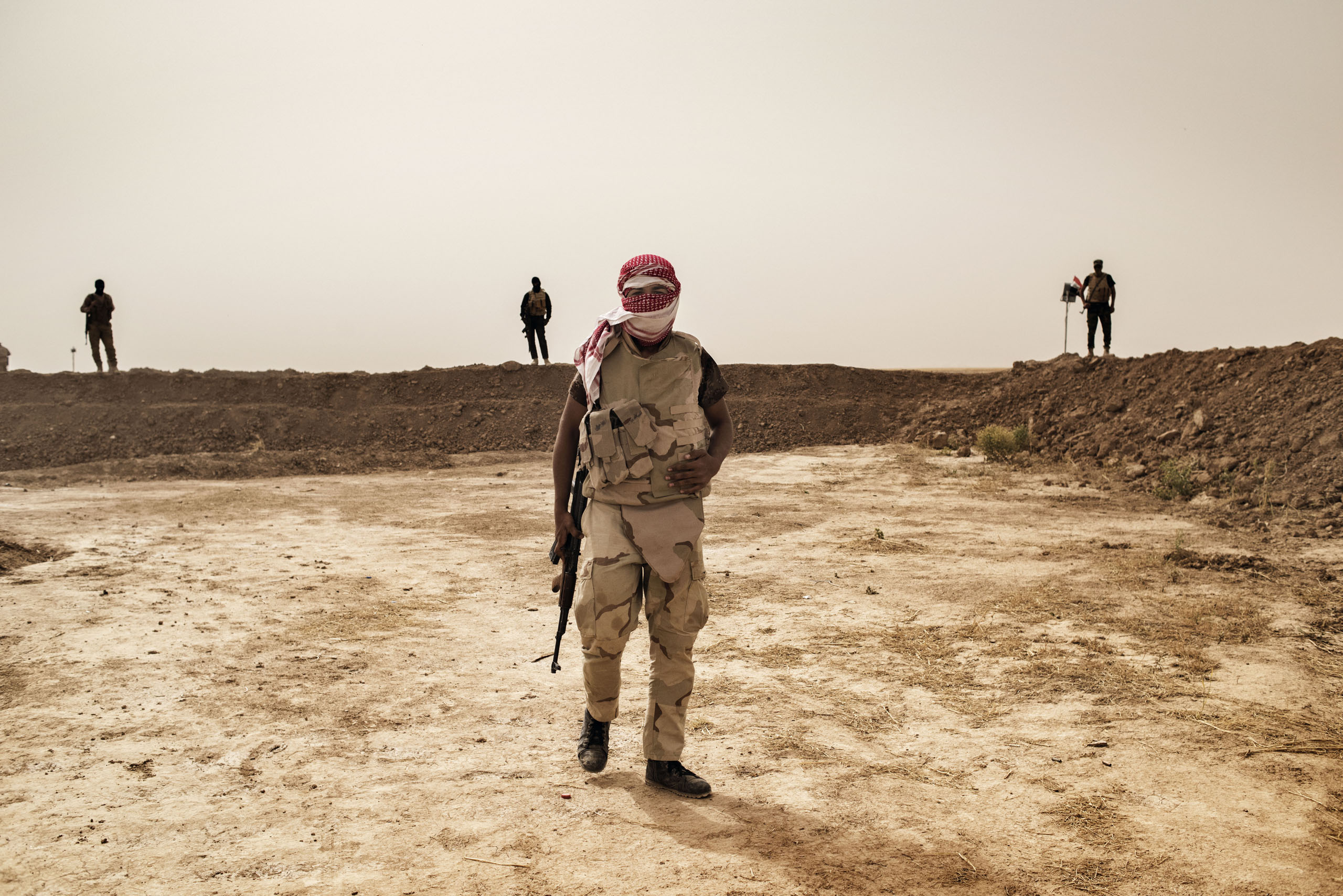 A member of the Hashid Watani (National Mobilization Force), a group of Sunni Arab Iraqi fighters opposed to ISIS, stands along the front line south of the city of Mosul, May 18 2016.