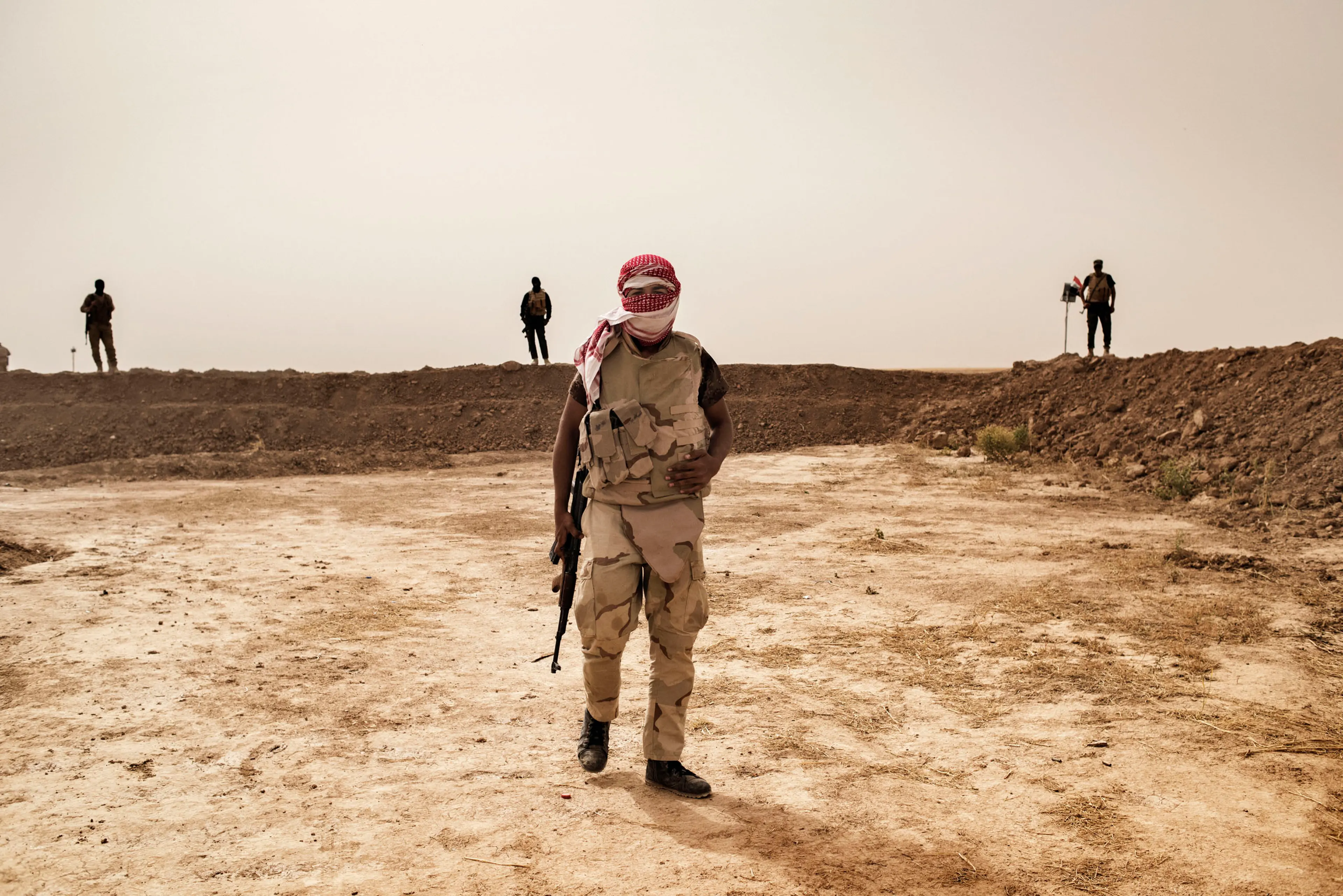 A member of the Hashid Watani (National Mobilization Force), a group of Sunni Arab Iraqi fighters opposed to ISIS, stands along the front line south of the city of Mosul, May 18 2016.