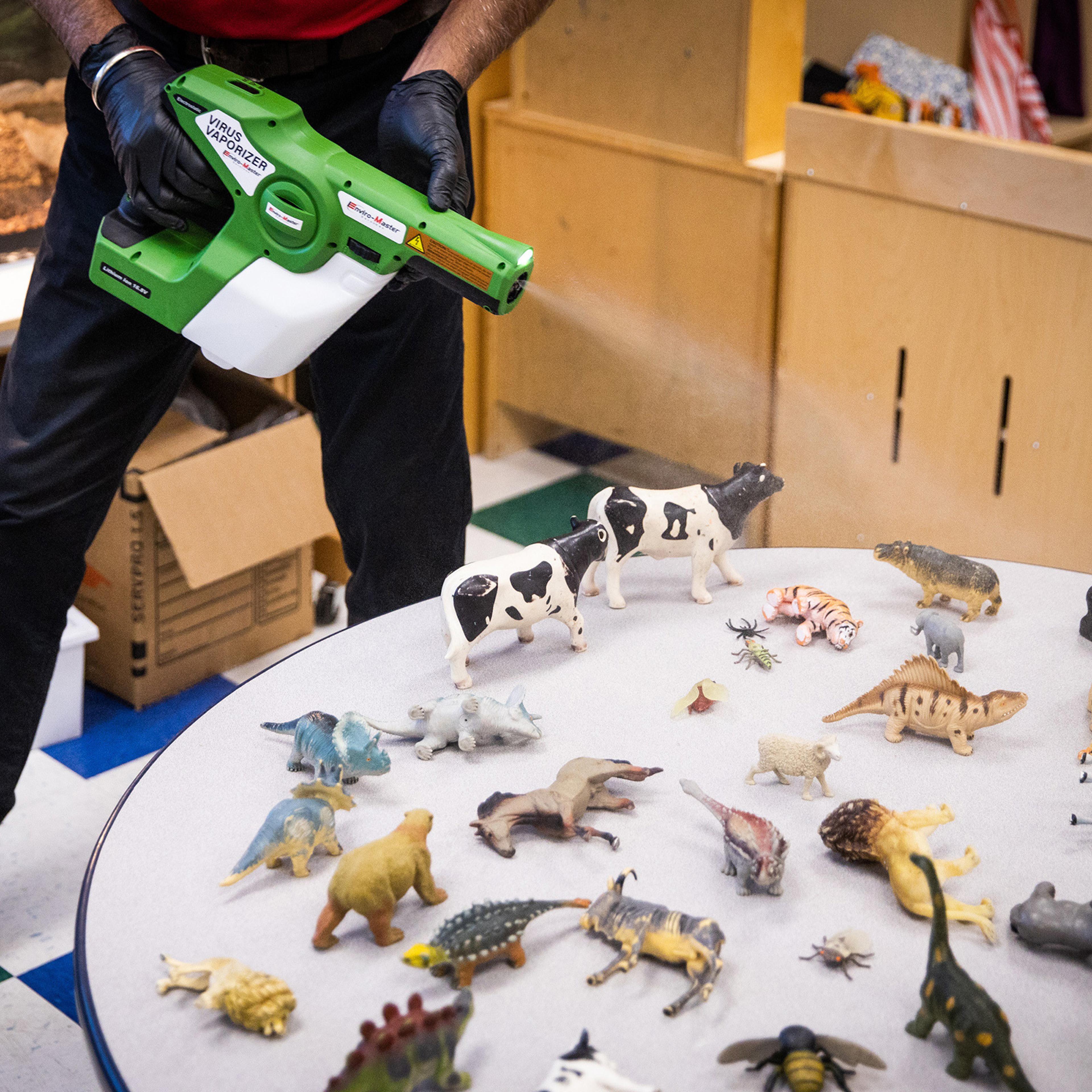 An Enviro-Master employee disinfects toys with an electrostatic virus vaporizer at a childcare center in Elk Grove, Calif. on July 23 amid the coronavirus pandemic
