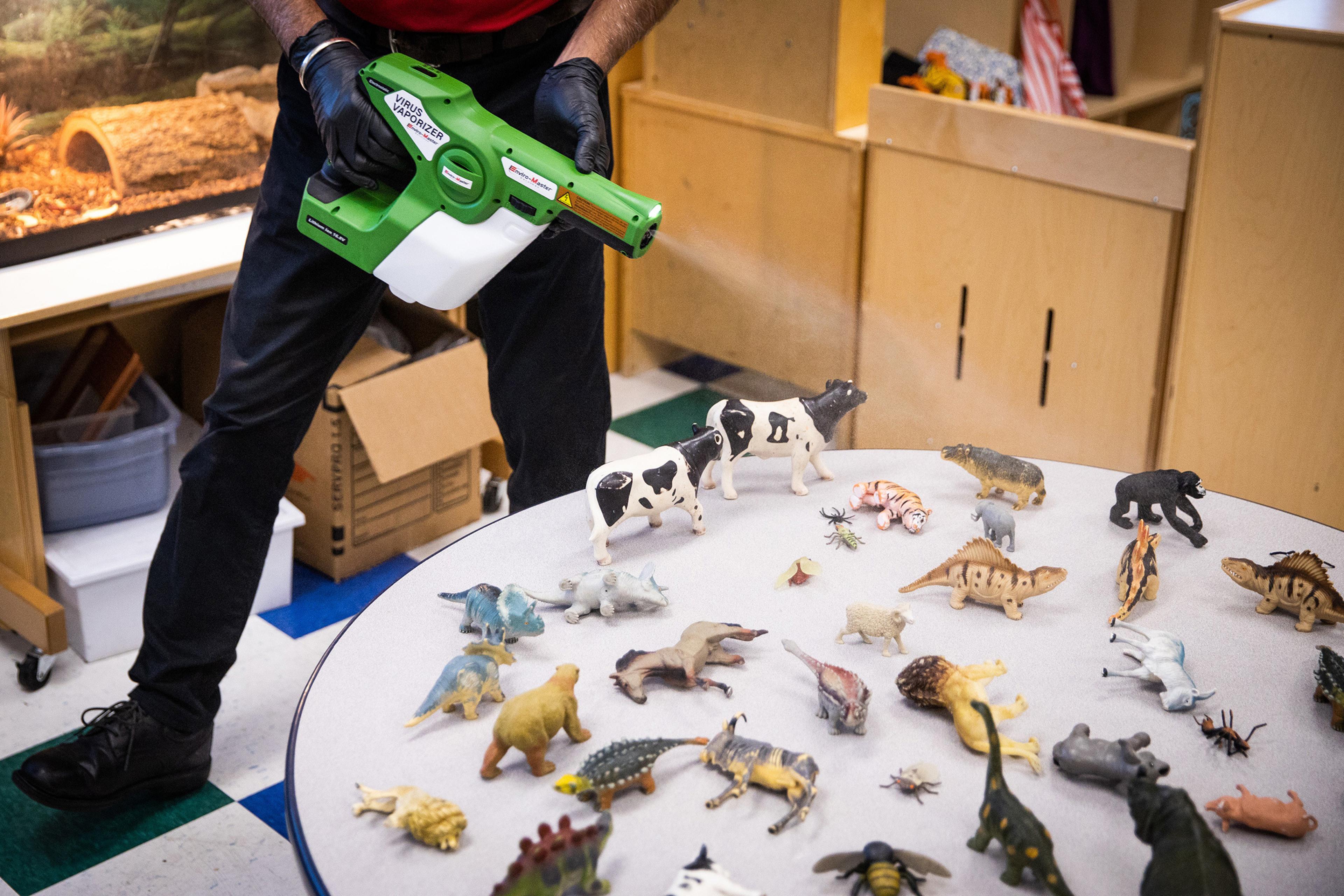 An Enviro-Master employee disinfects toys with an electrostatic virus vaporizer at a childcare center in Elk Grove, Calif. on July 23 amid the coronavirus pandemic