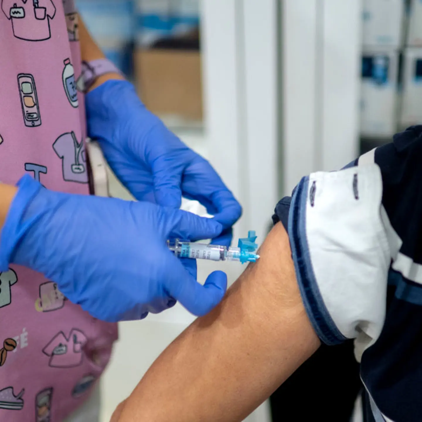 A woman receives a flu vaccine.