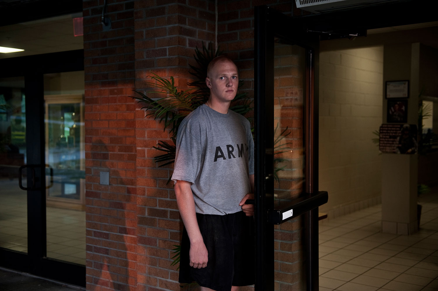 A recruit holds open the door to the mess hall during breakfast hours. Sept. 1, 2011.